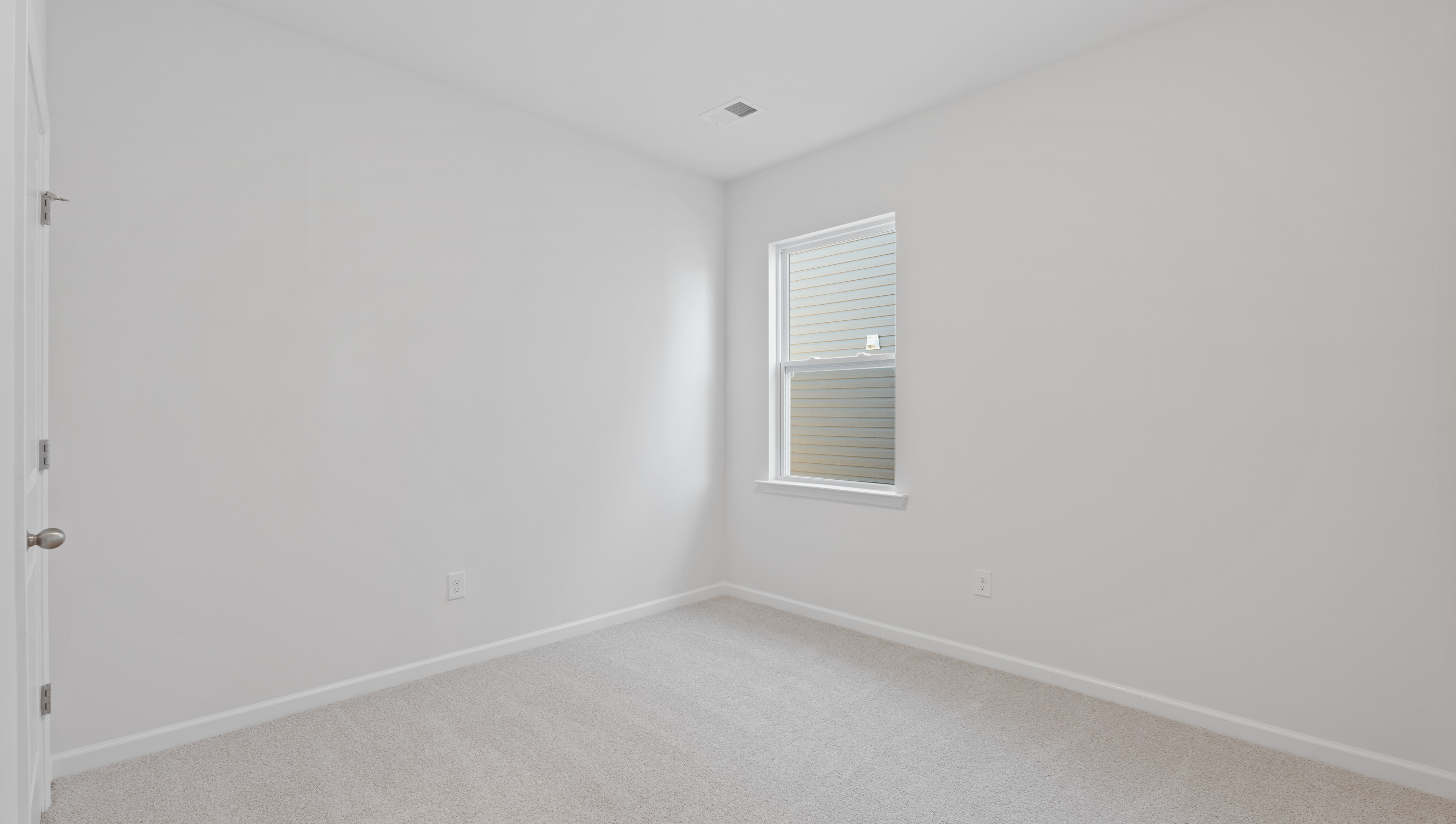 Bedroom with carpet and window.