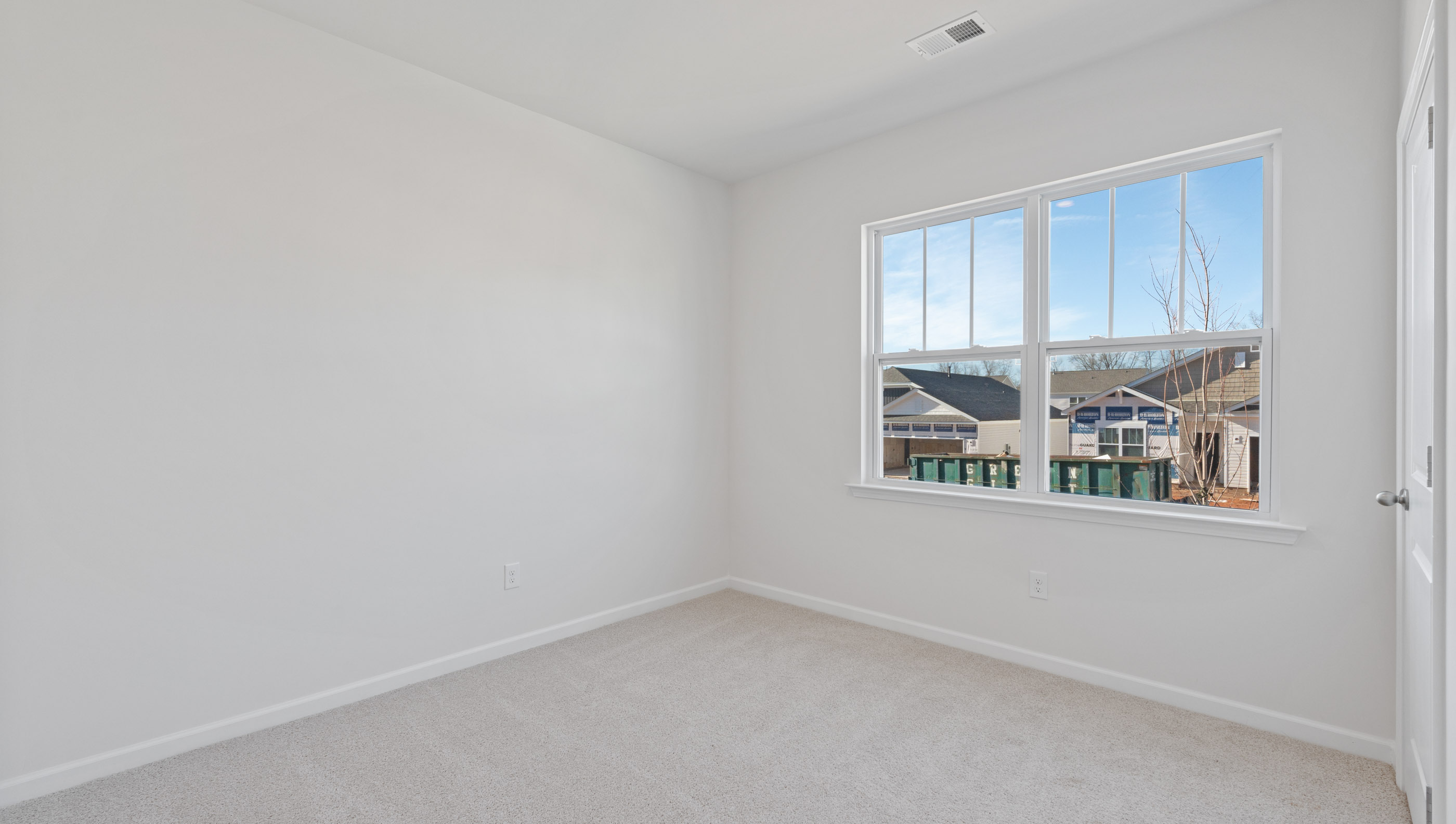 Bedroom with carpet and window.
