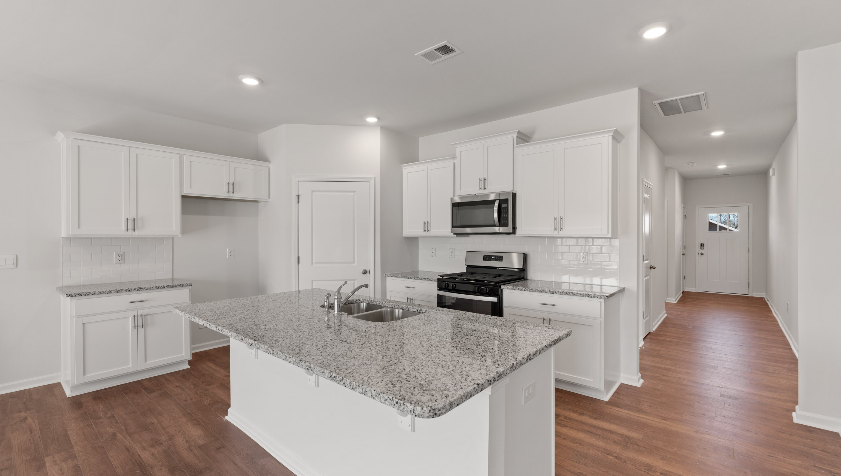 Kitchen and island with granite countertops.
