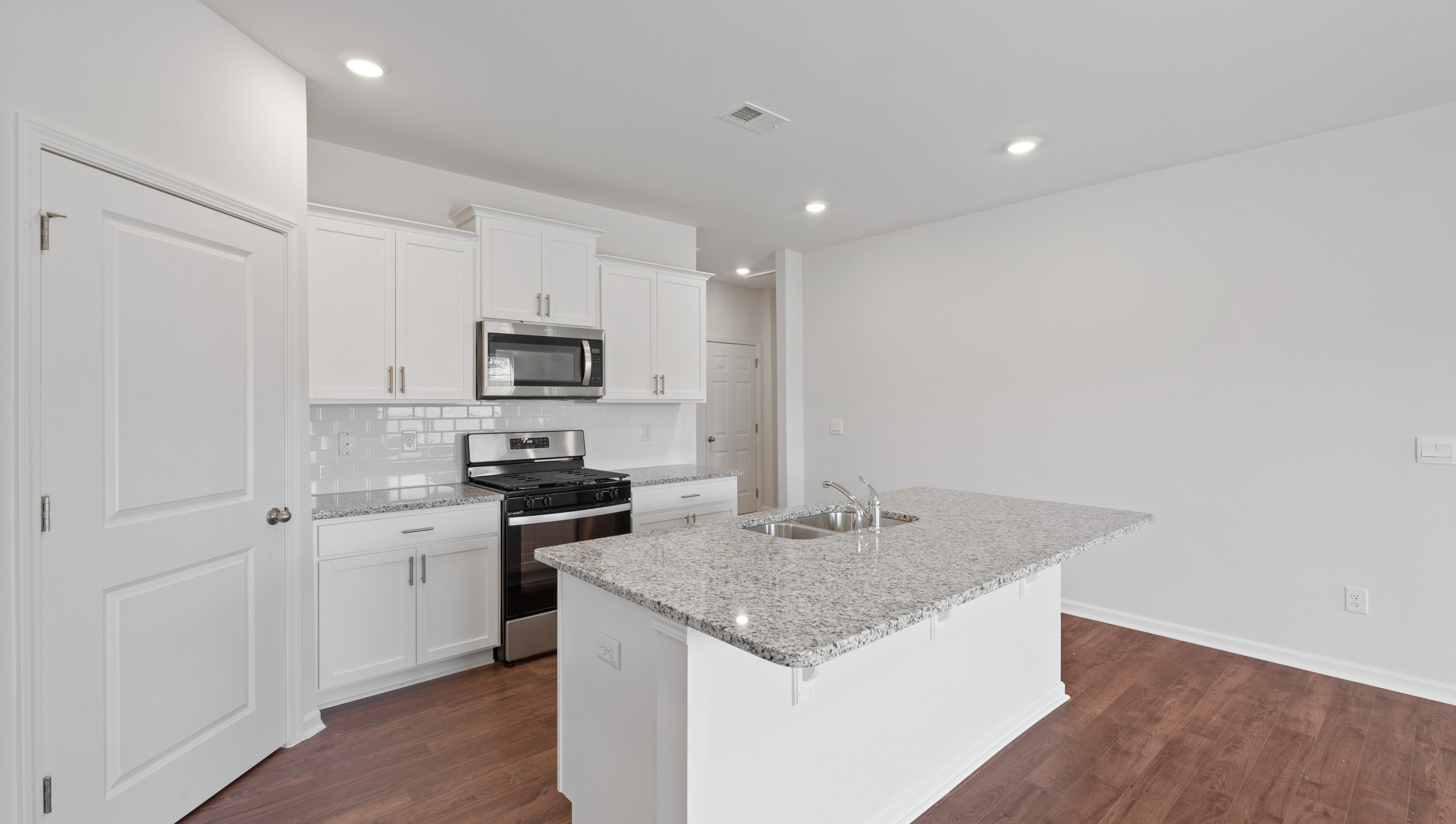 Kitchen and island with granite countertops.