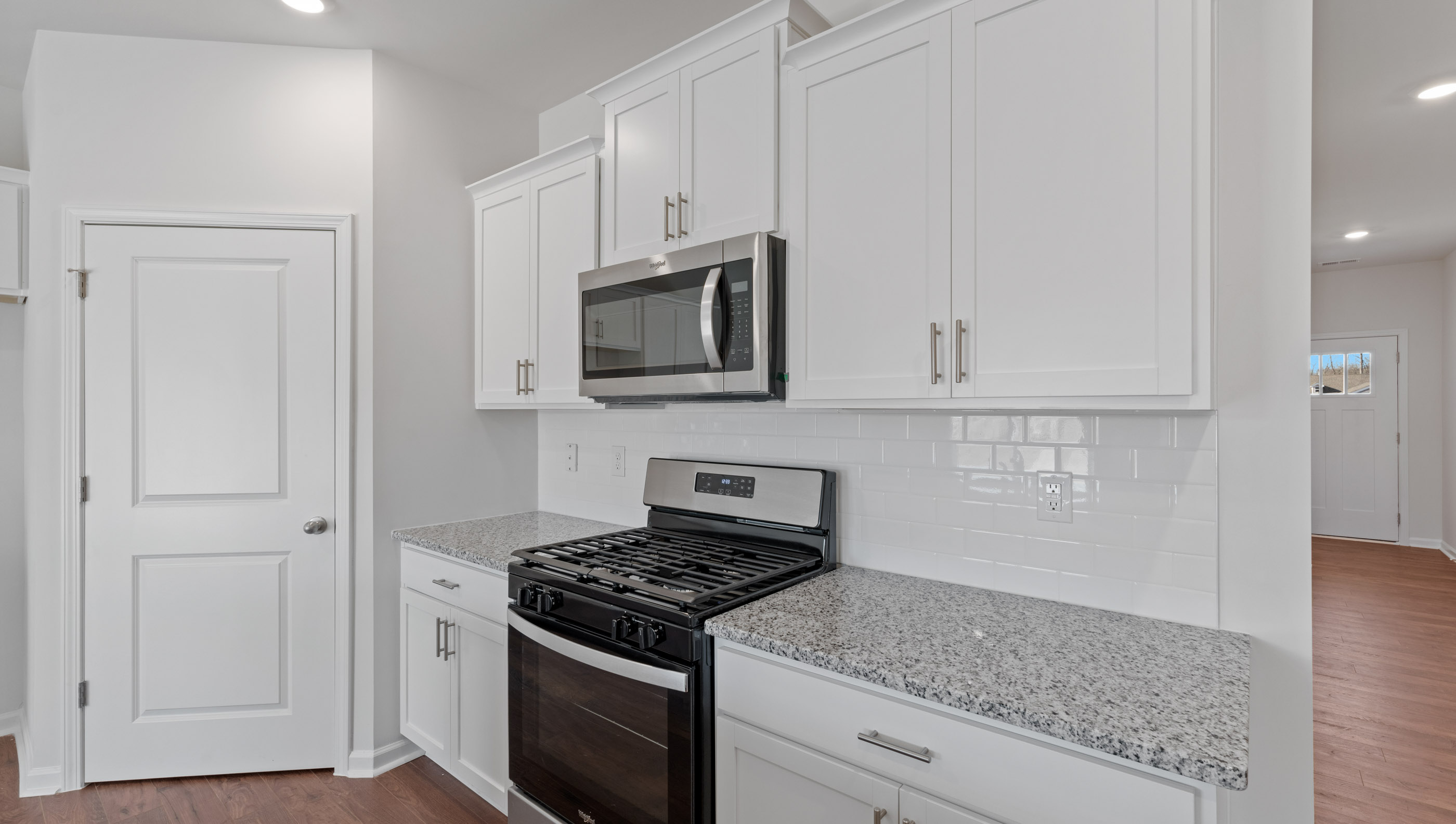 Kitchen with granite countertops and stainless steel appliances.