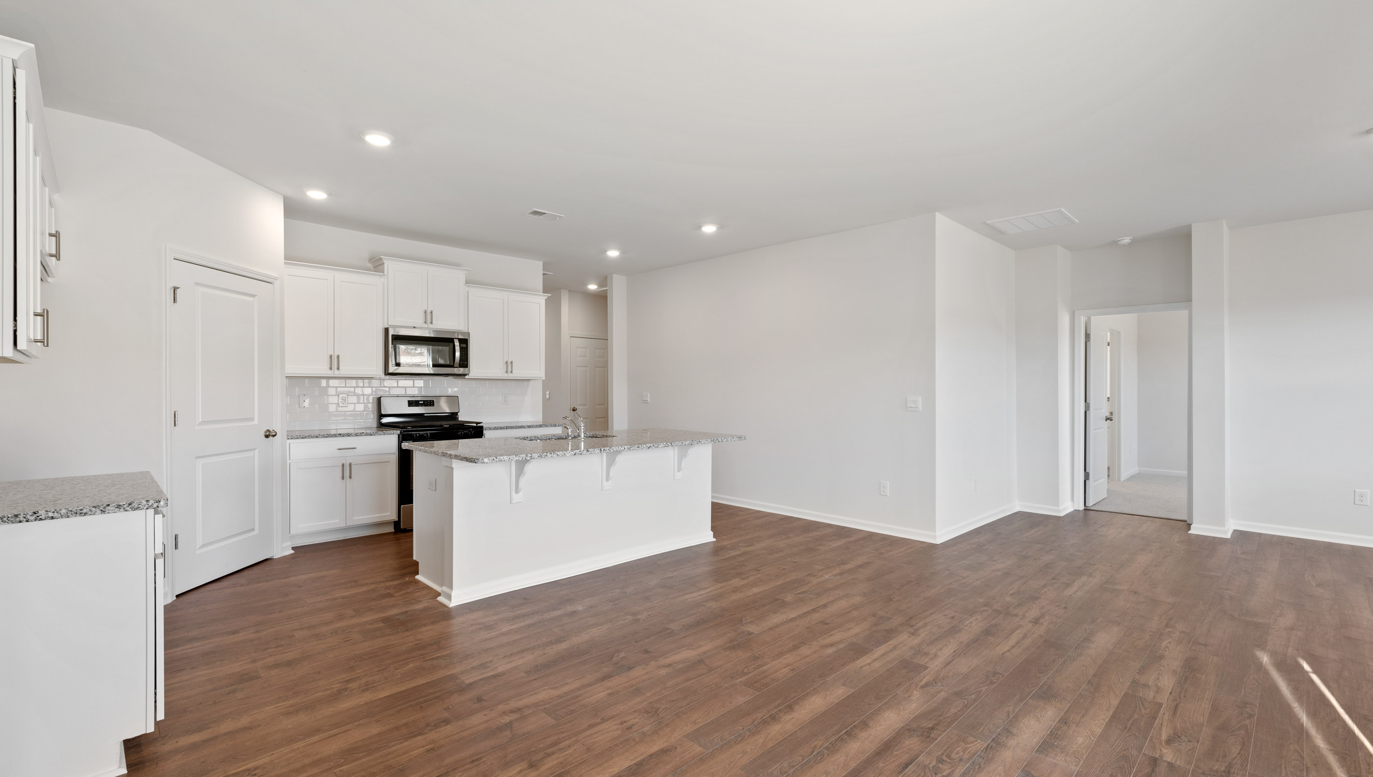 Kitchen and island with granite countertops.