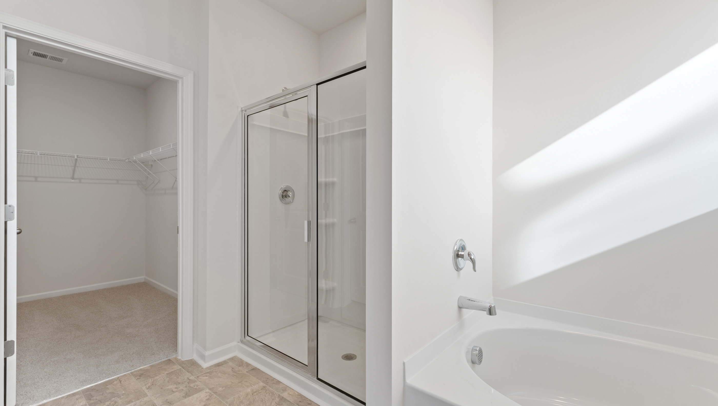Bathroom with tub and walk in shower.