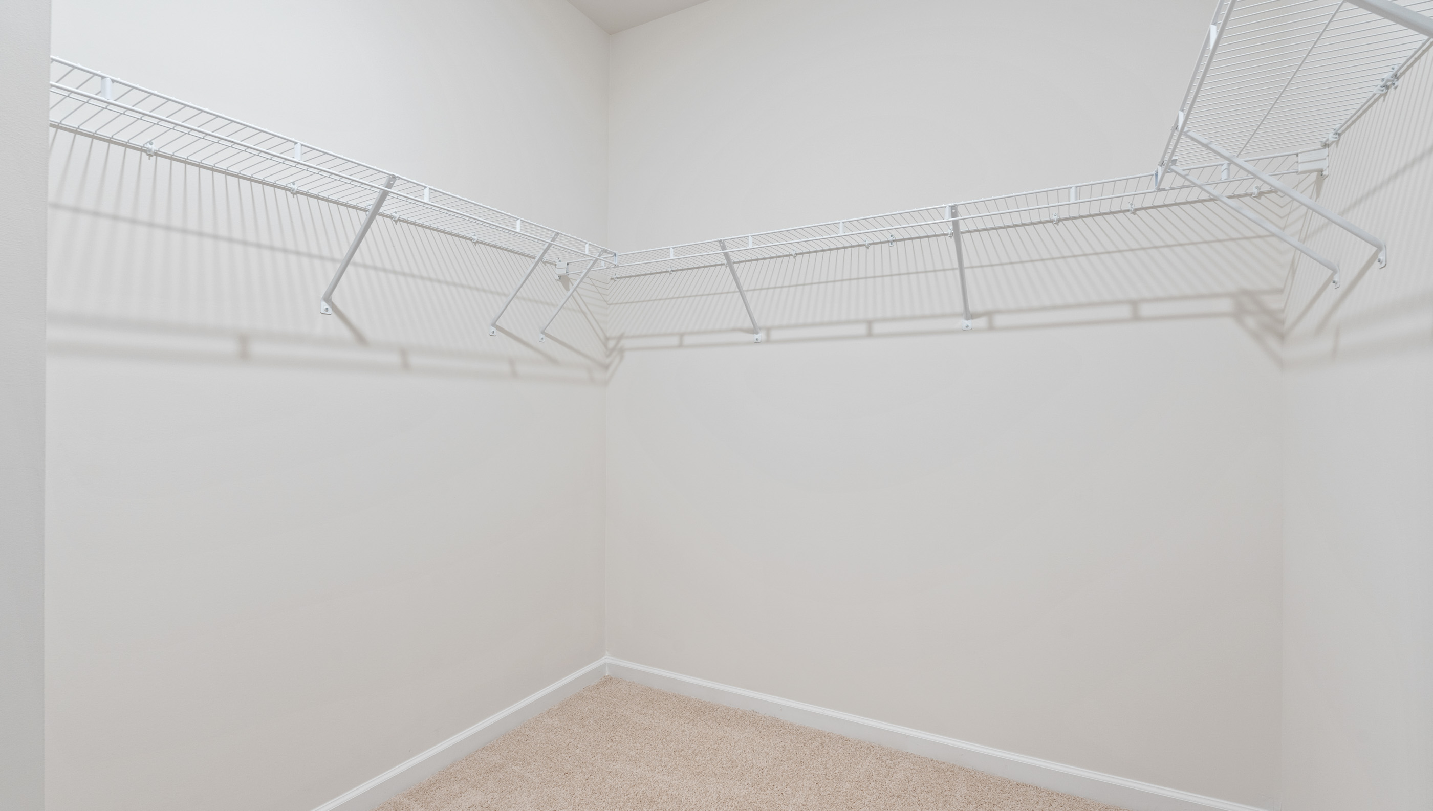 Walk in closet with shelves.