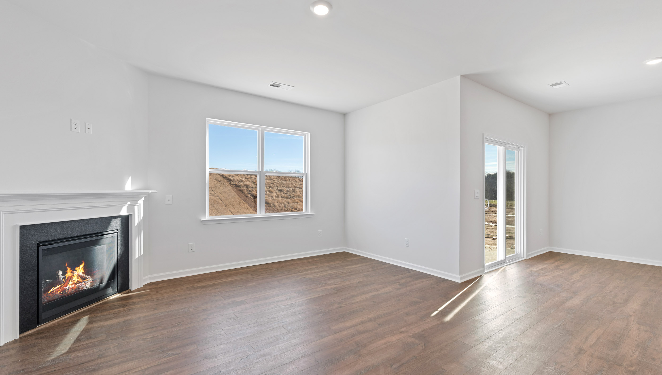 Family room with fireplace and windows.
