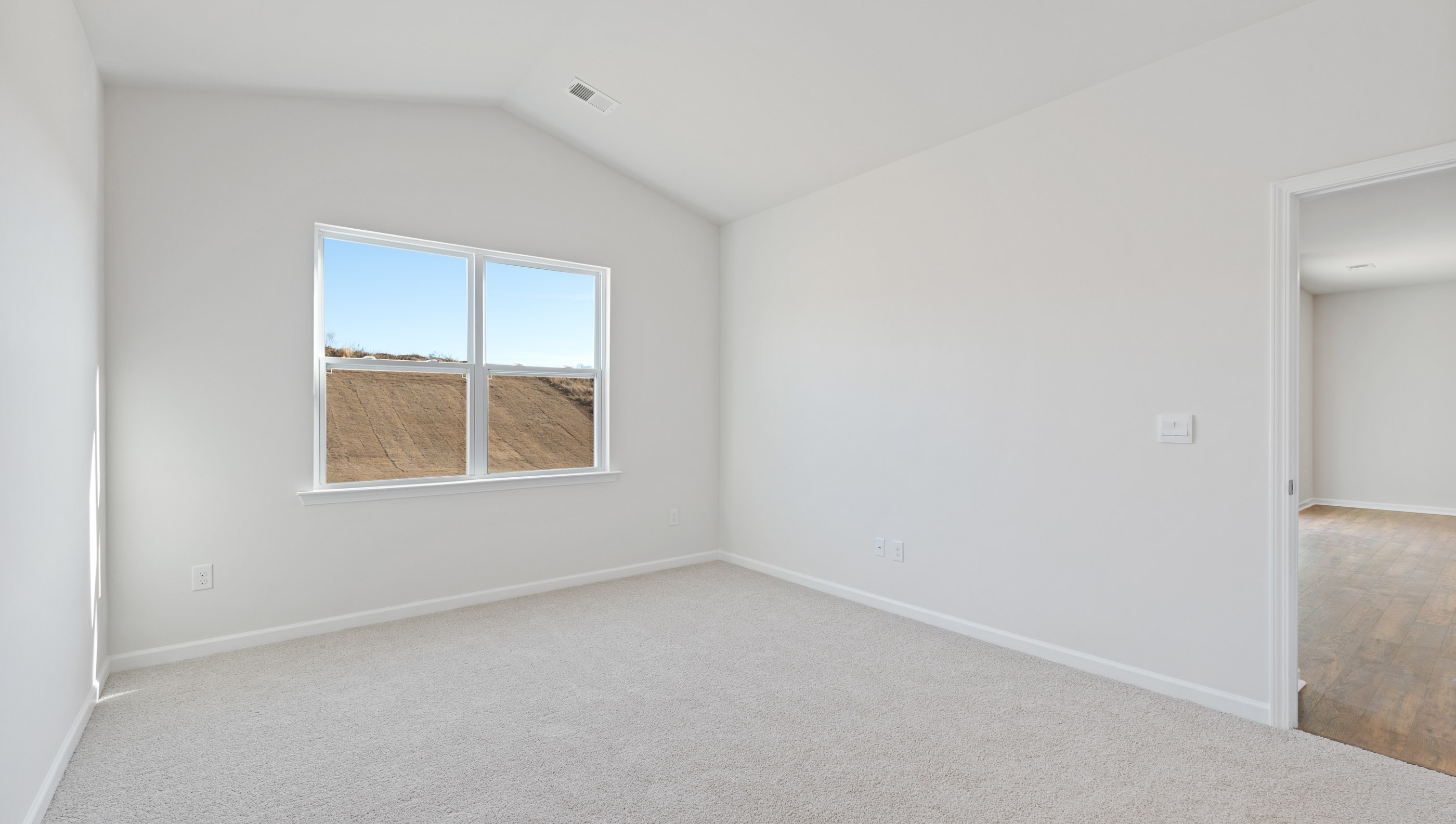 Bedroom with carpet and window.