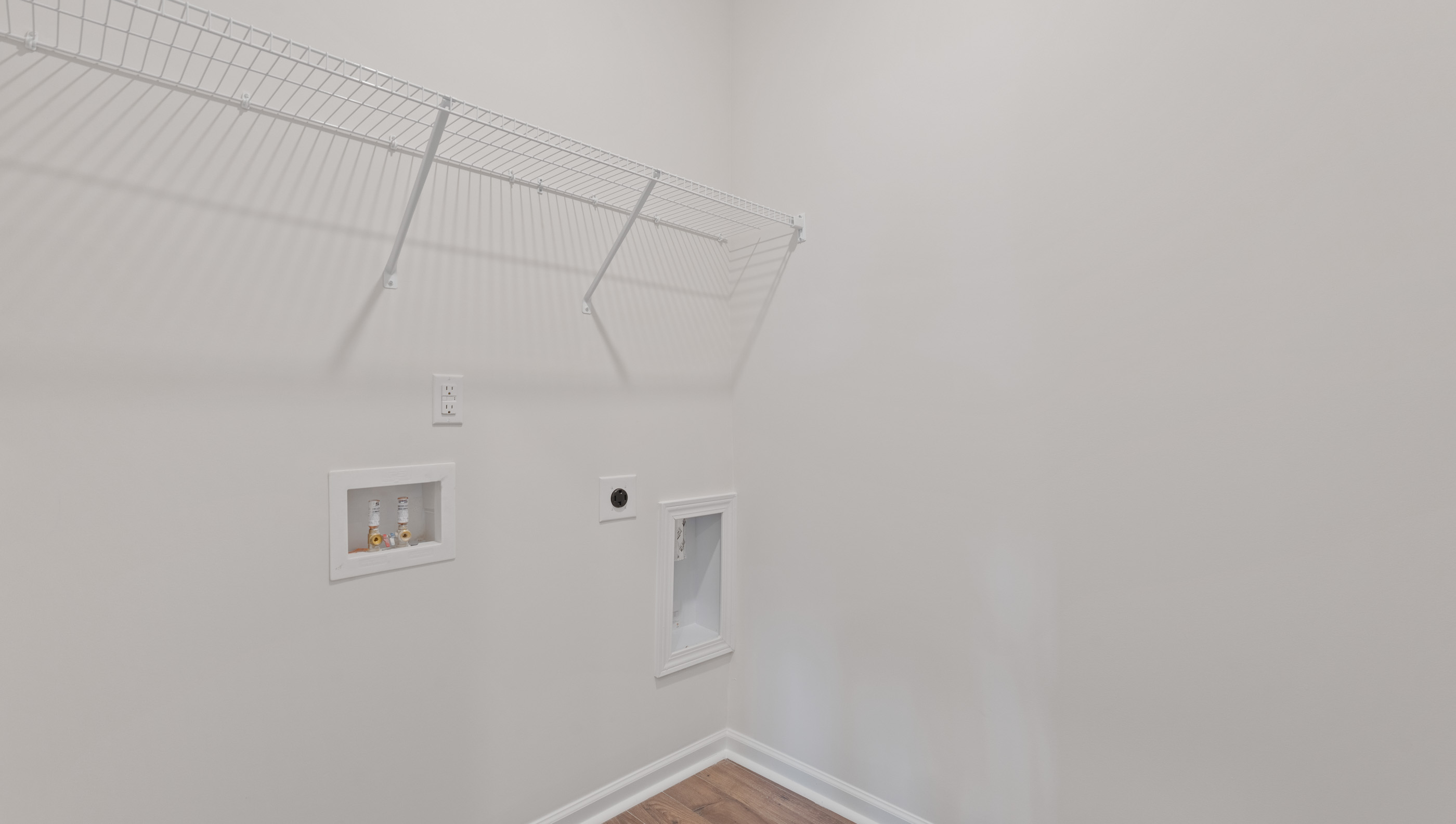 Walk in laundry with shelves.