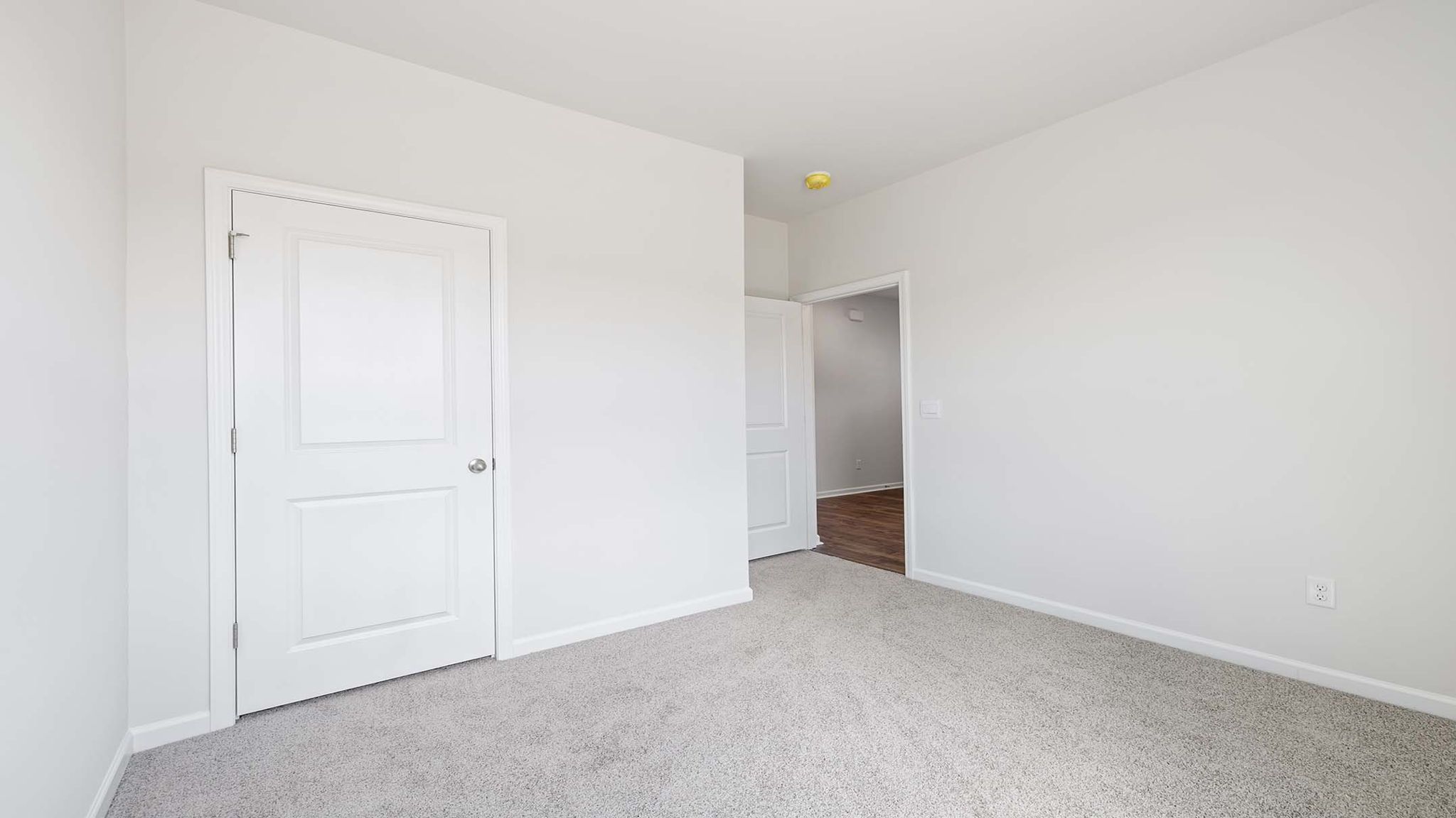 Bedroom with carpet and windows.