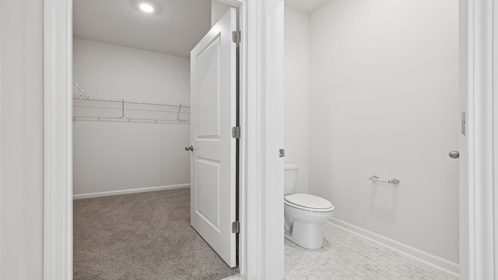 Bathroom with closet and walk in shower.