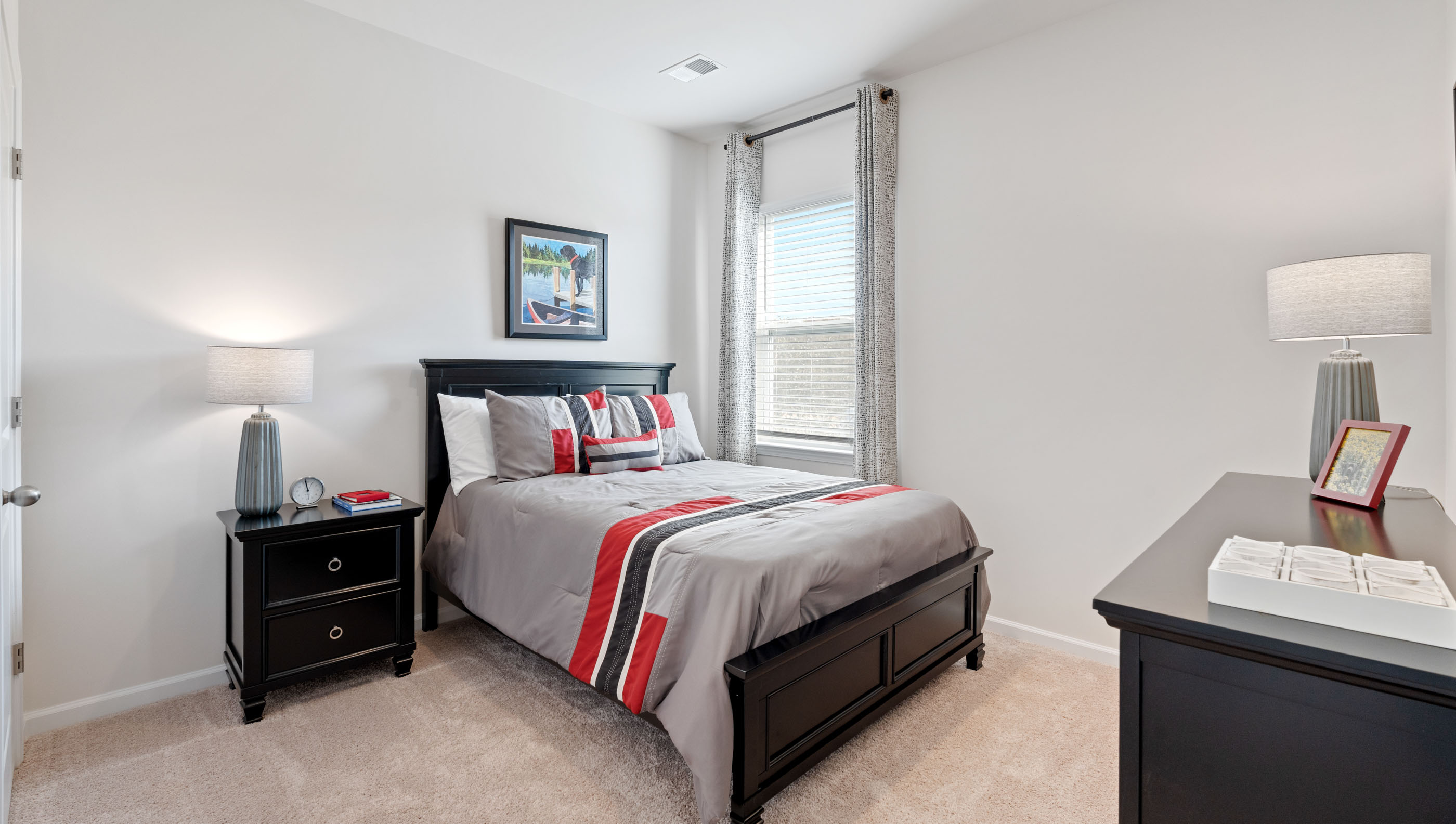 Bedroom with carpet and window.