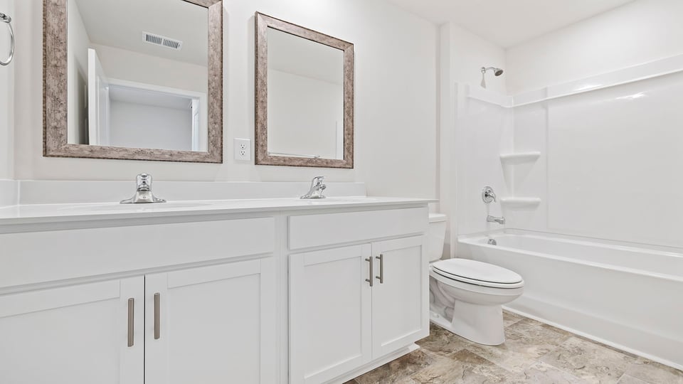 Bathroom with dual vanity and tub.