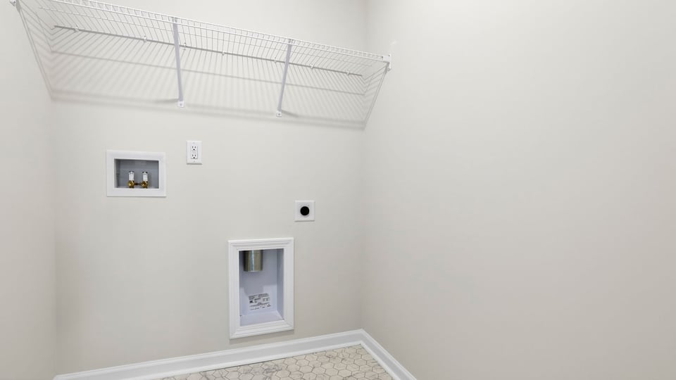 Laundry room with hanging storage racks.