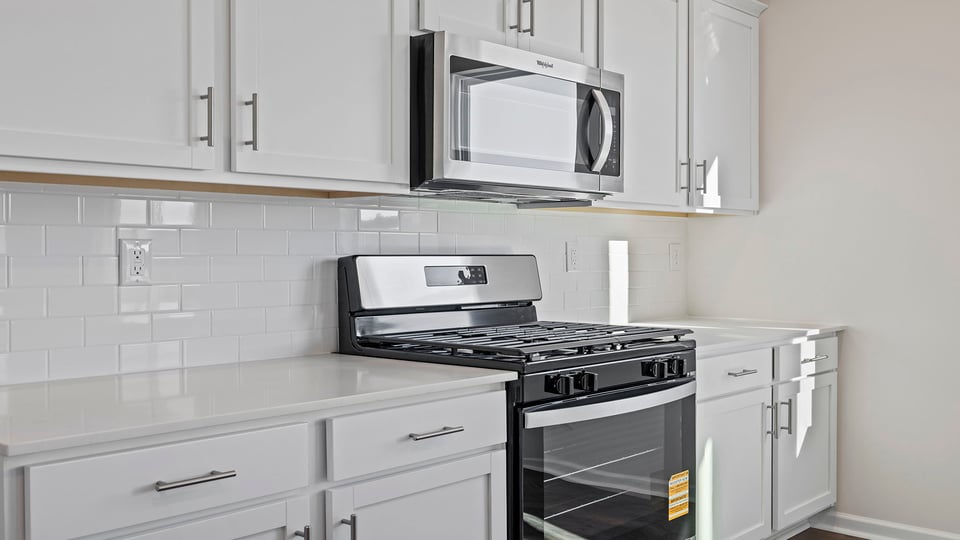 Kitchen with granite countertop and stainless steel appliances.