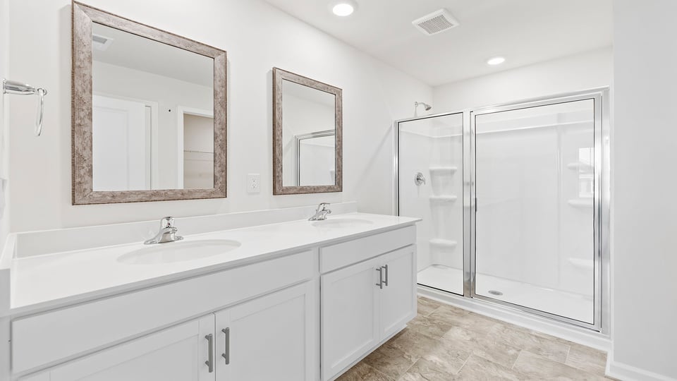 Bathroom with vanity and walk in shower.