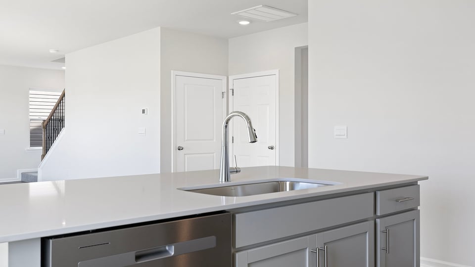 Kitchen with island with granite countertops.