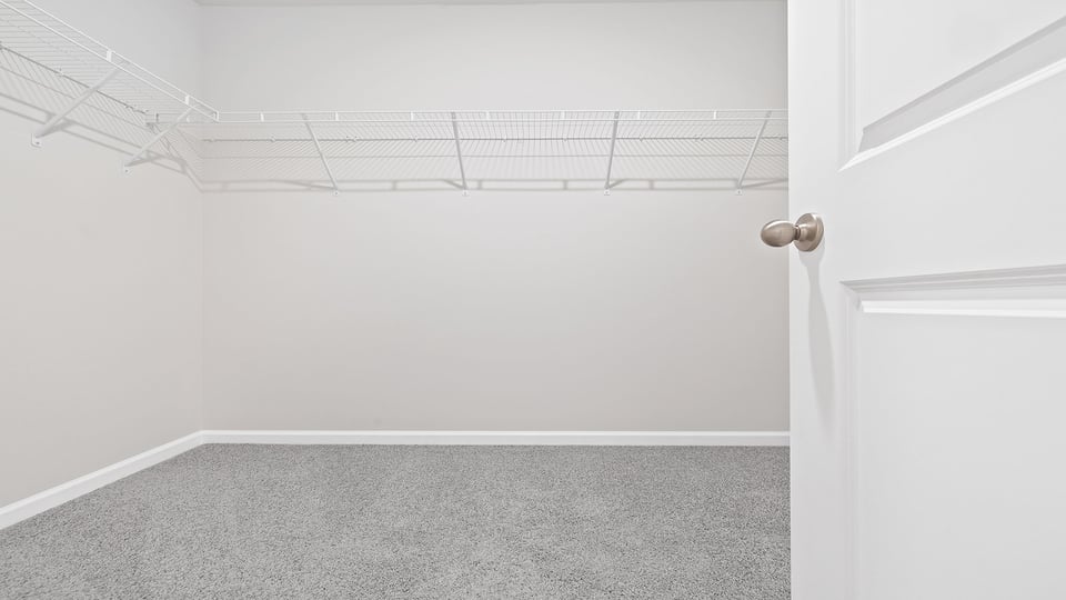 Walk in closet with shelves.
