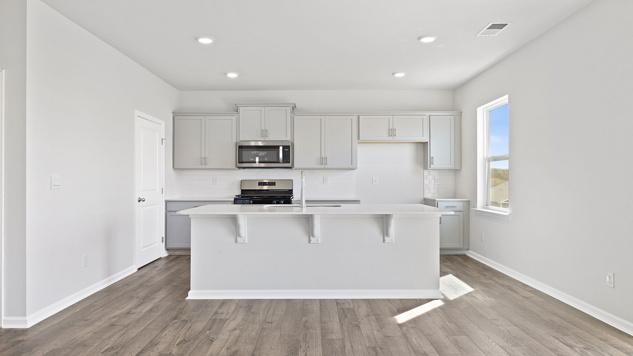 Kitchen and island with granite countertops.