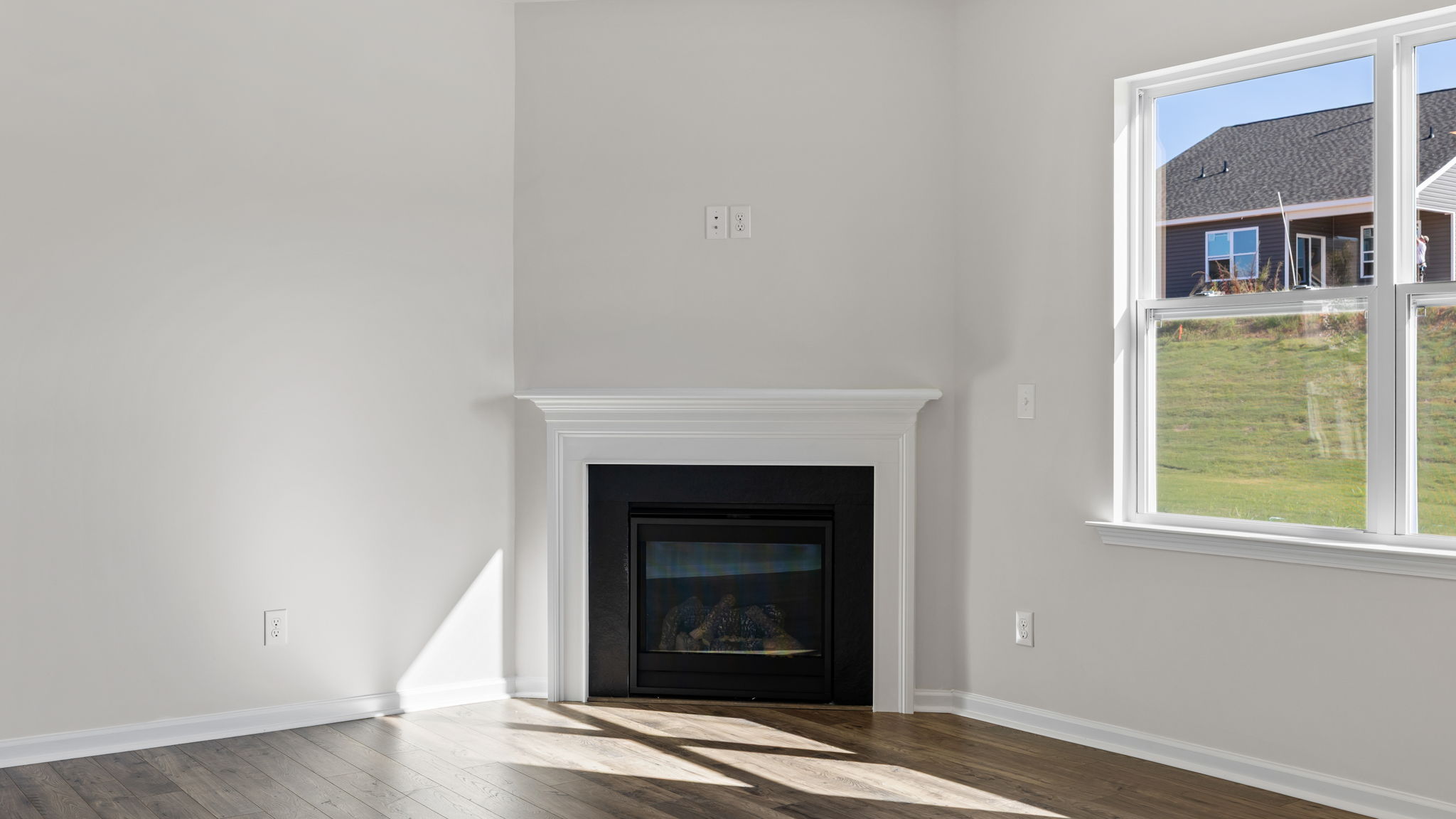 Great room with windows and fireplace.