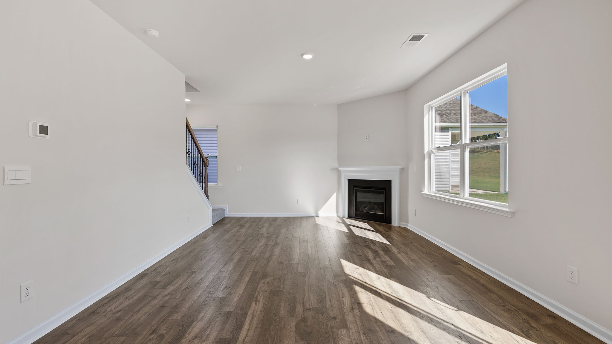 Great room with windows and fireplace.
