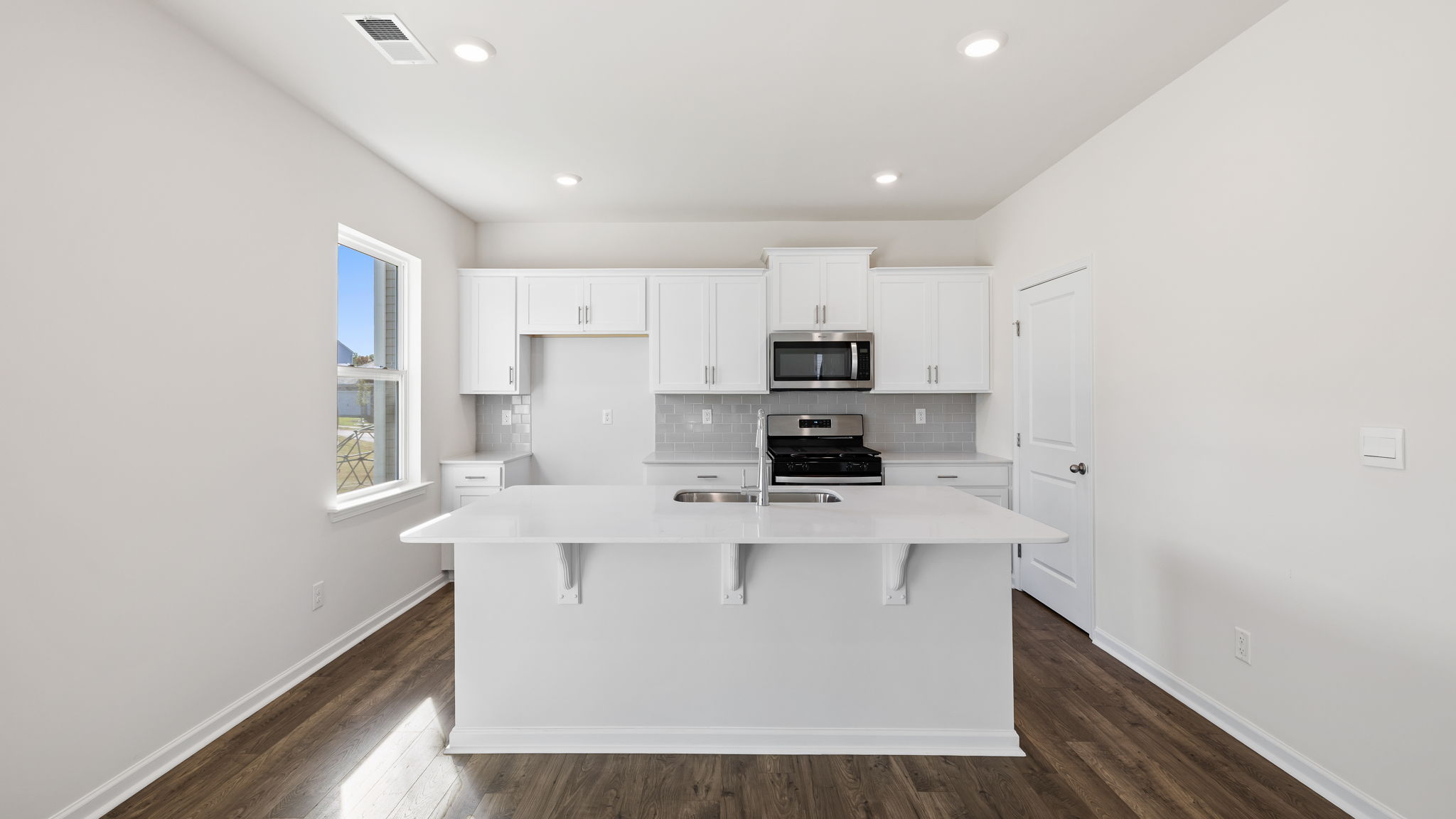 Kitchen and island with granite countertops.