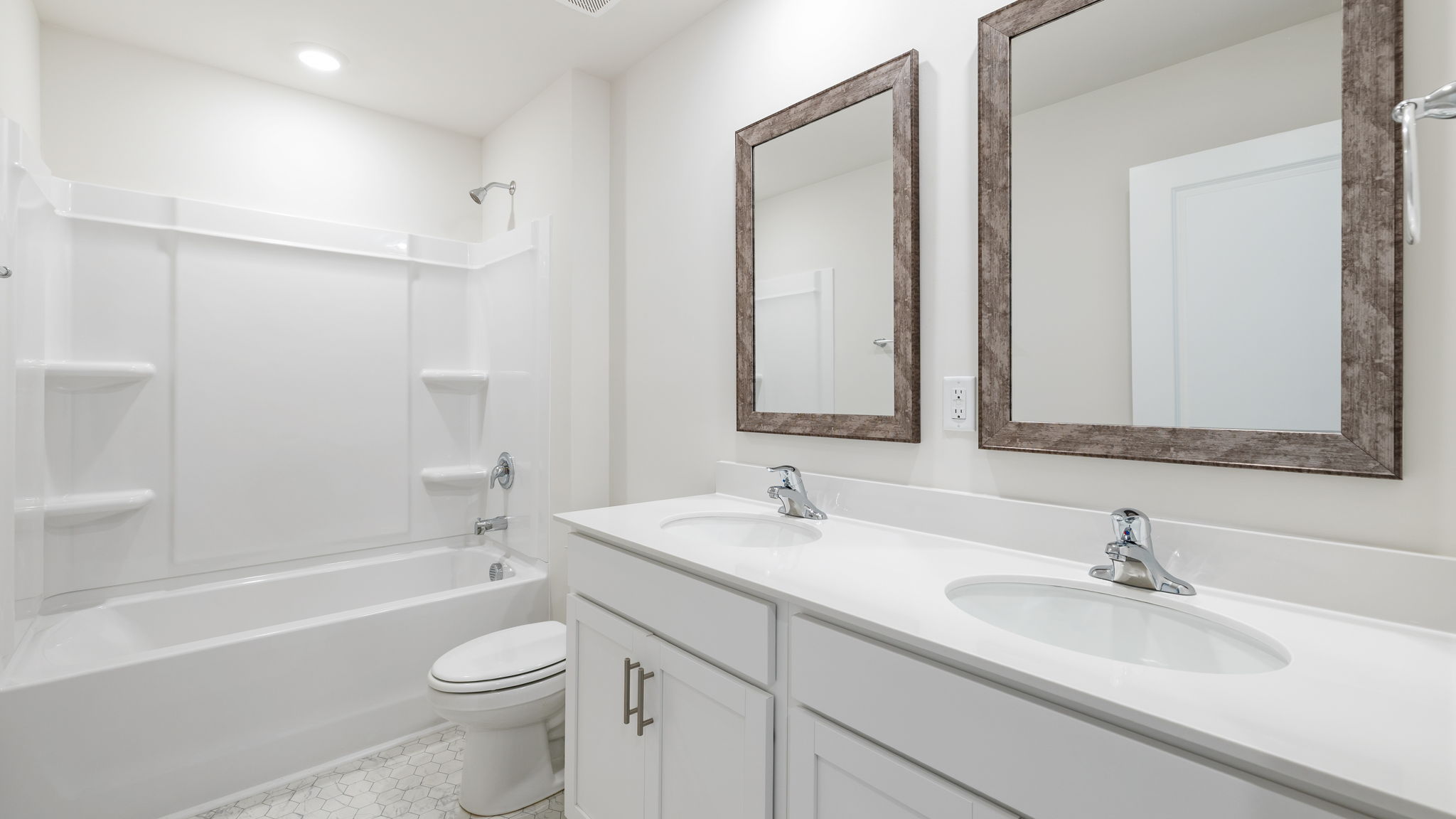 Bathroom with dual vanity and tub.