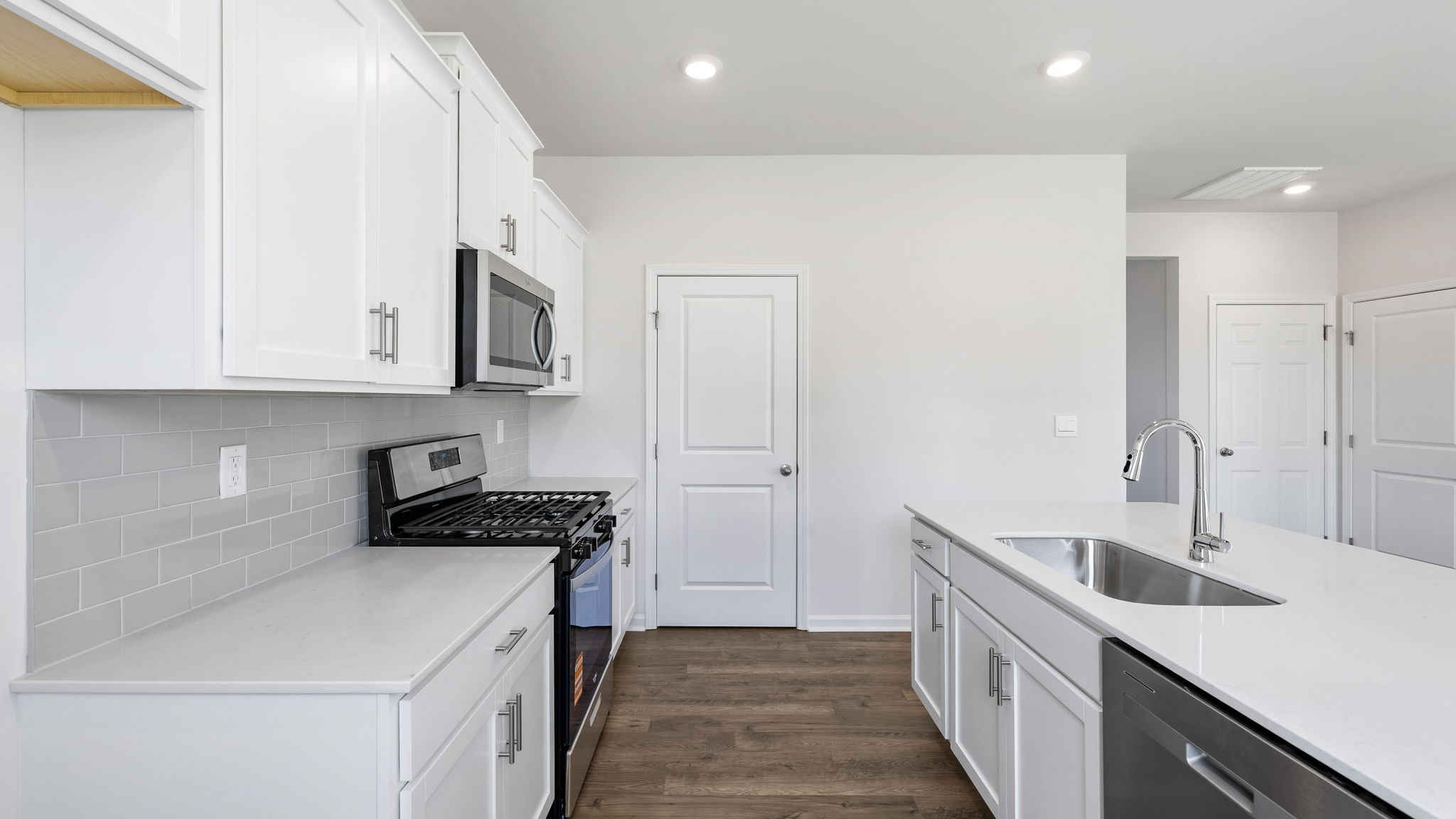 Kitchen and island with granite counter tops.