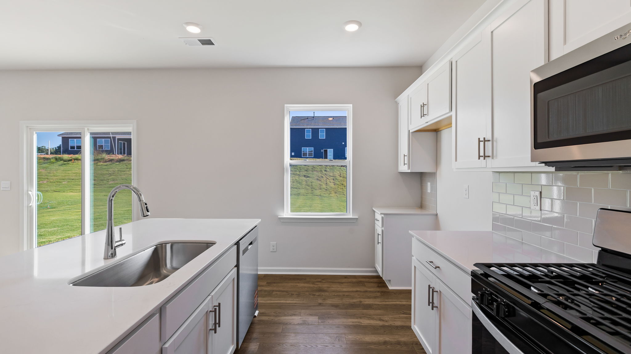 Kitchen and island with granite counter tops.