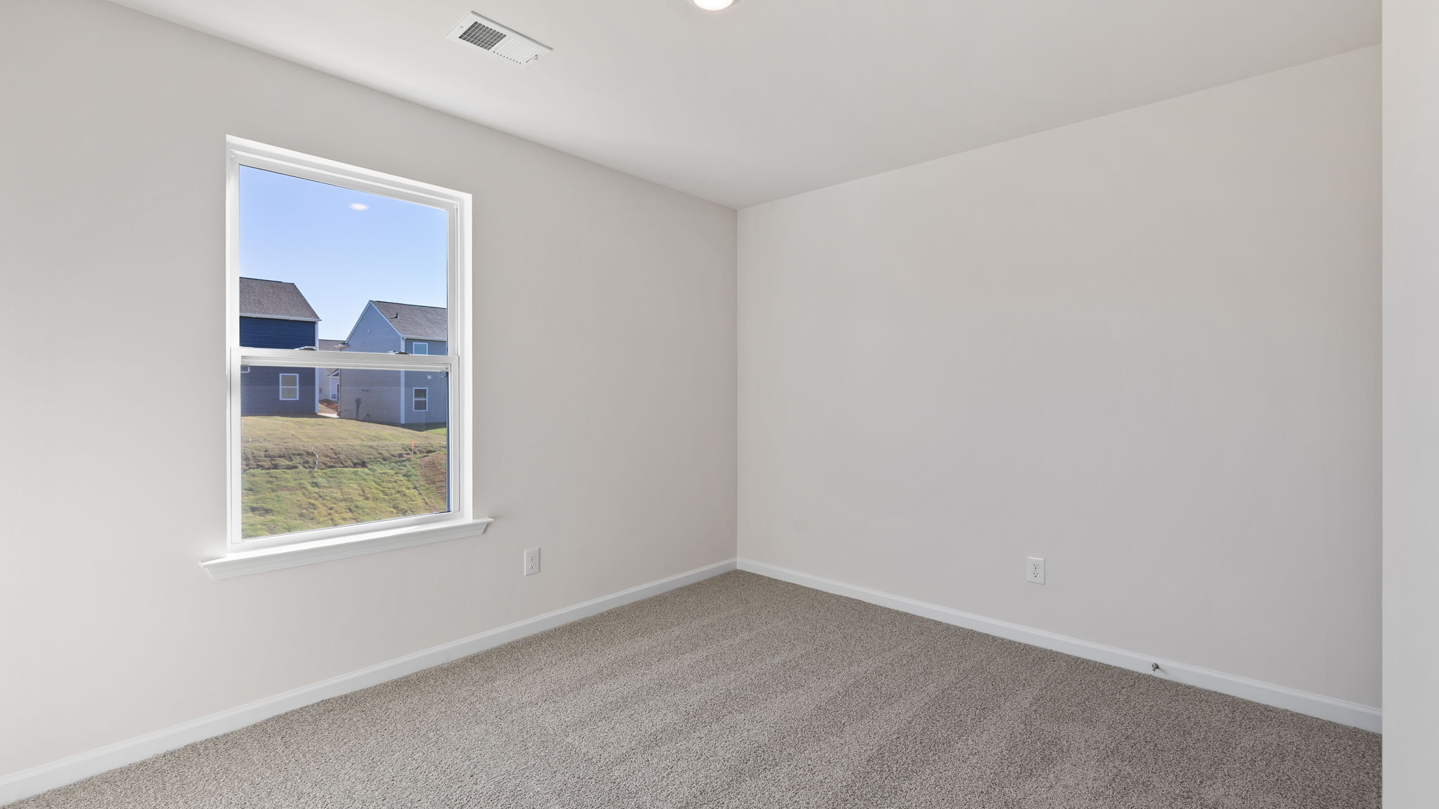 Bedroom with carpet and window.