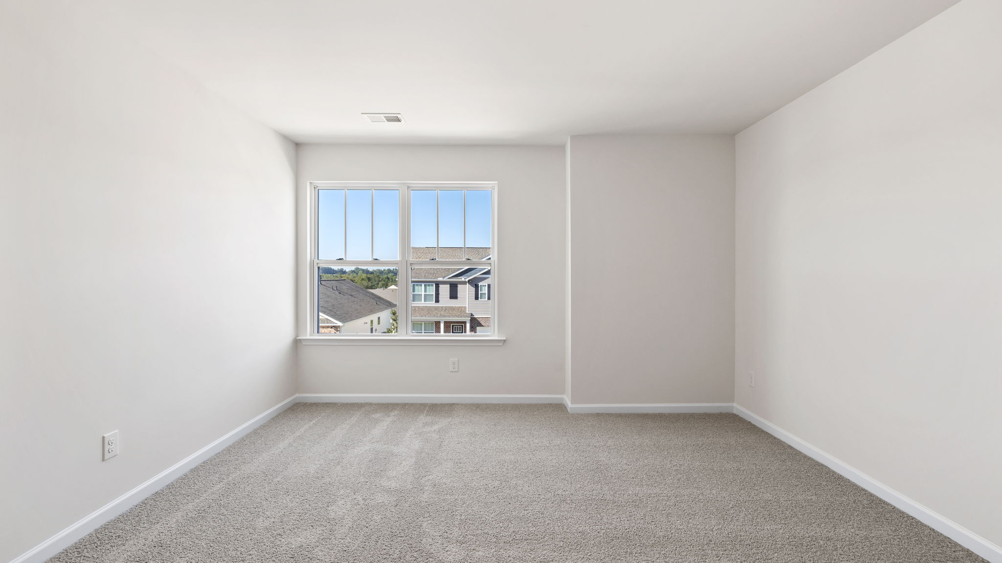 Bedroom with carpet and window.