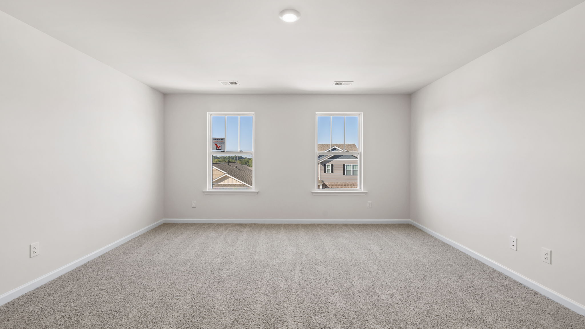 Bedroom with carpet and window.