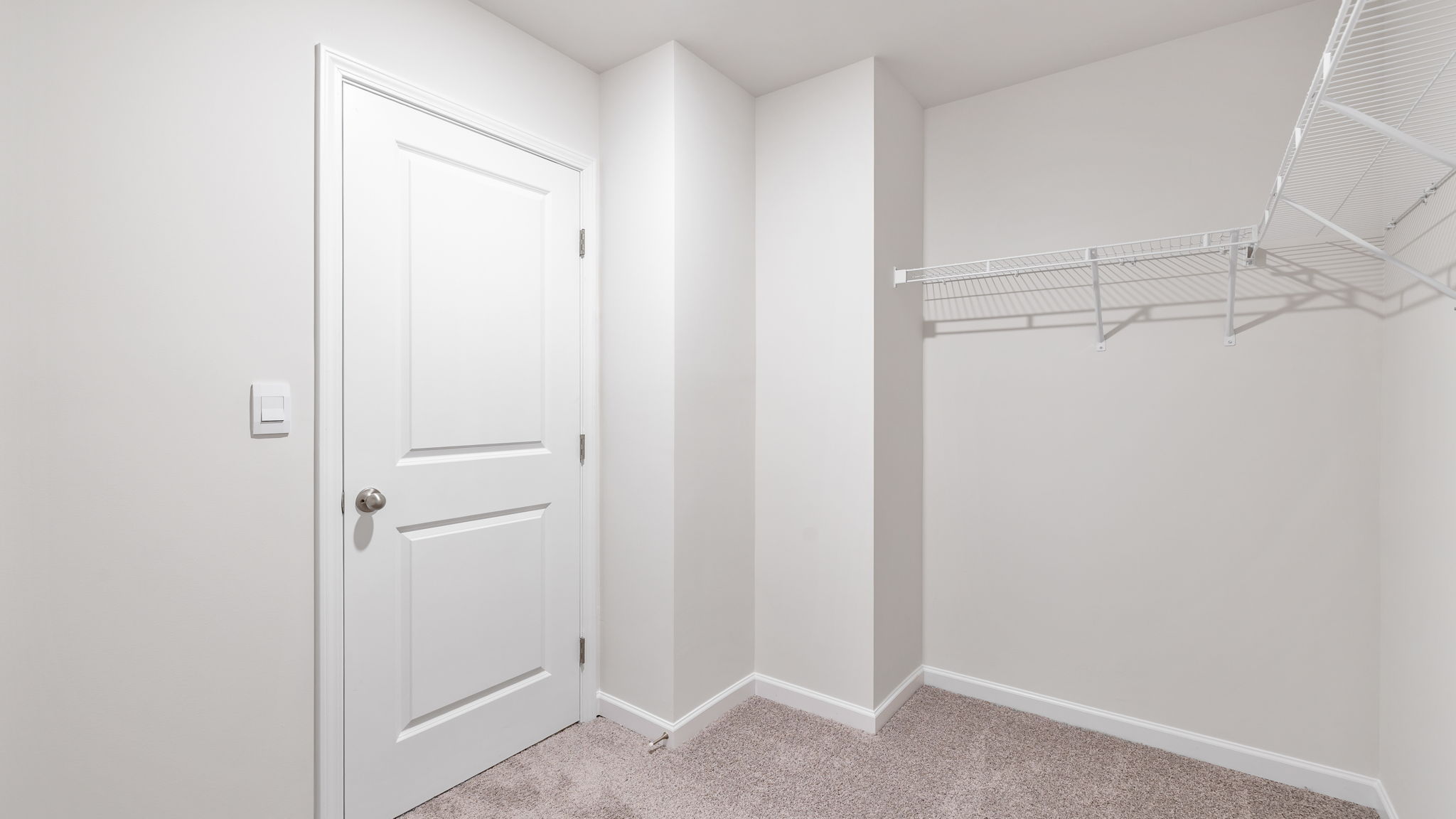 Walk in closet with shelves.