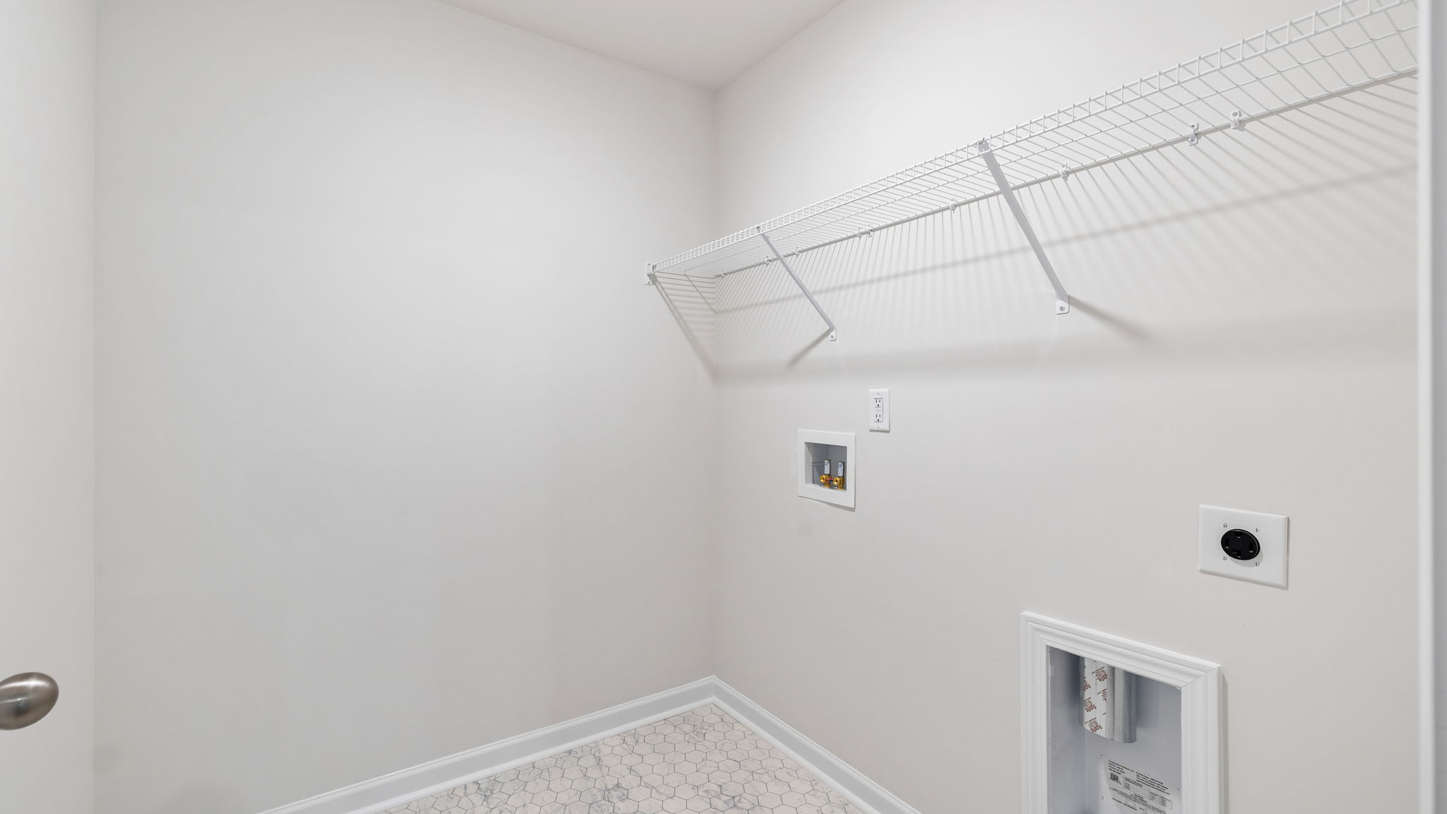 Walk in laundry with shelves.