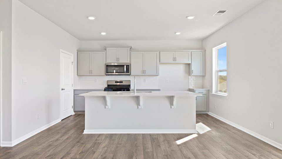 Kitchen and island with granite countertops.