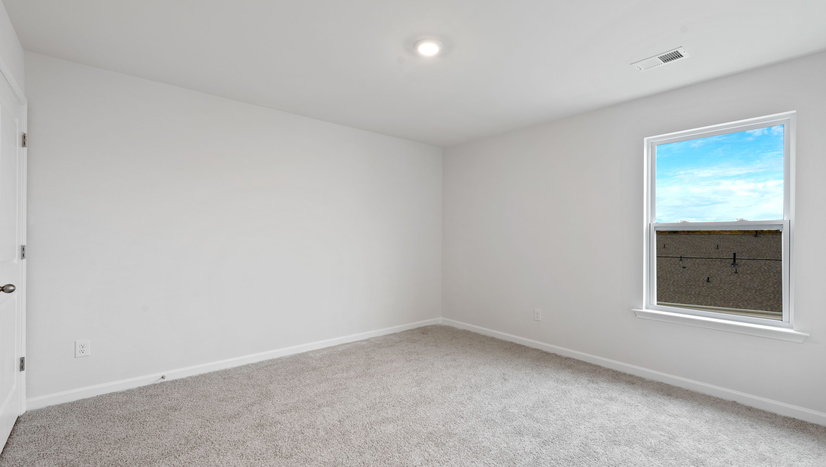 Bedroom with carpet and window.
