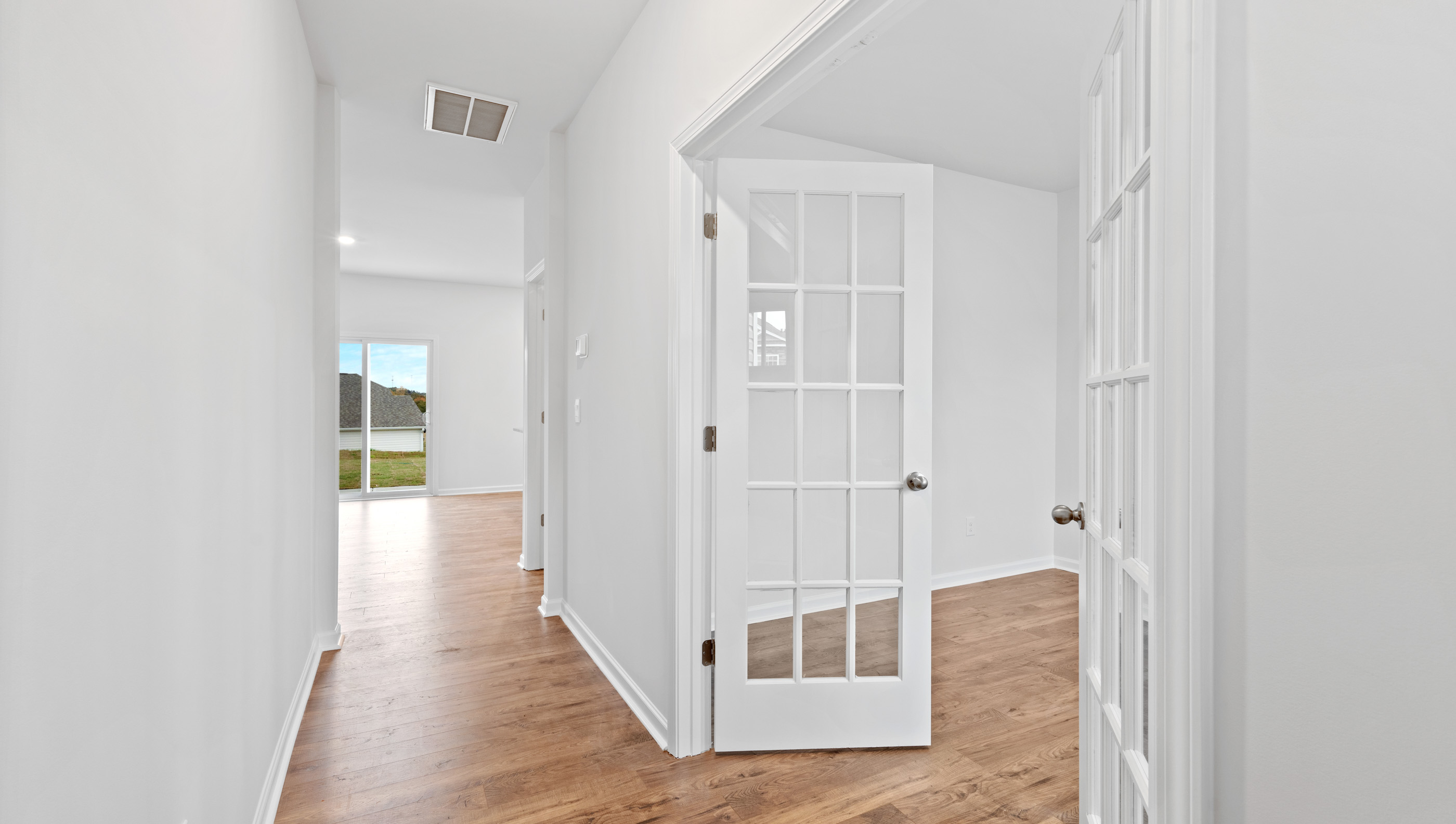 Entry way into home Showing doors to study.