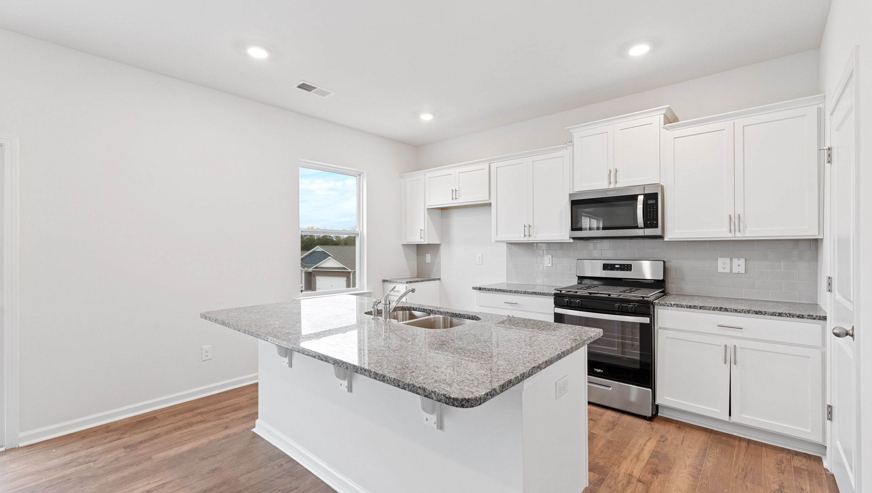 Kitchen and island with quartz countertops.