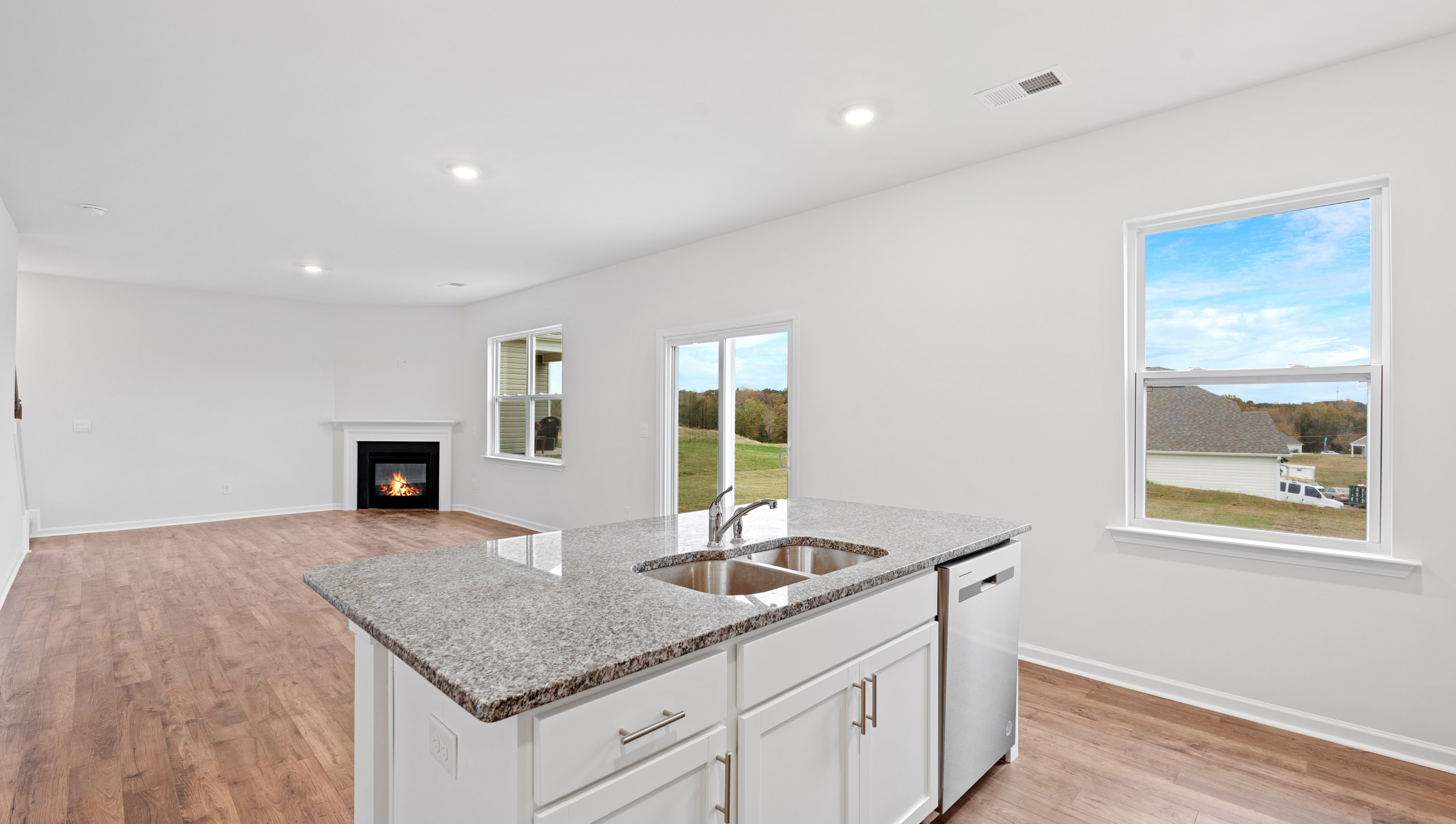 Kitchen and island with view of windows.