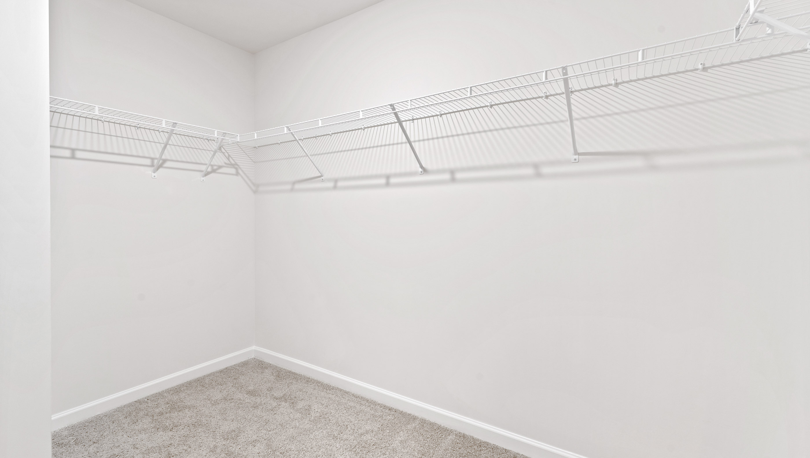 Walk in closet with shelves.