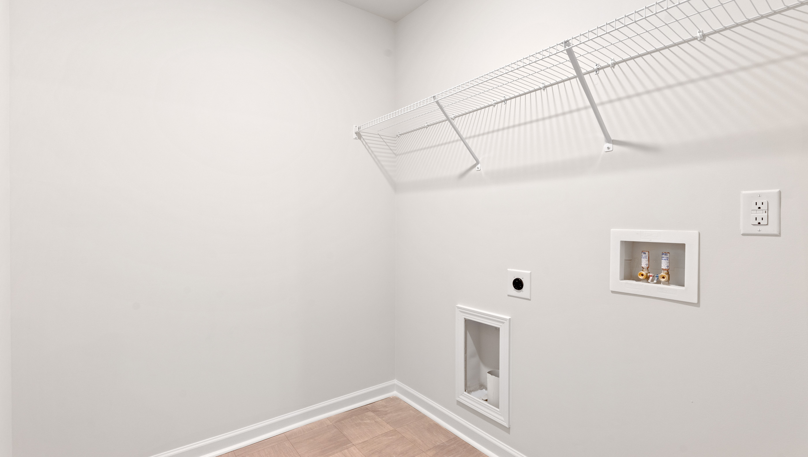 Walk in laundry with shelves.