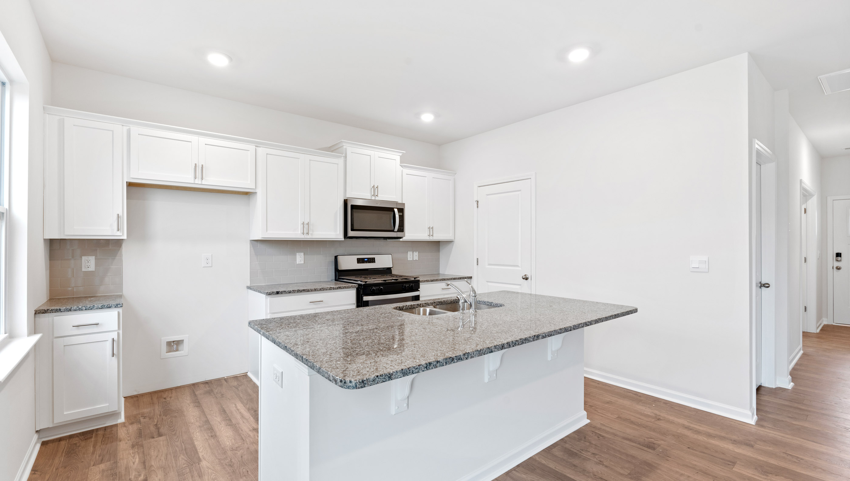 Kitchen and island with granite countertop.