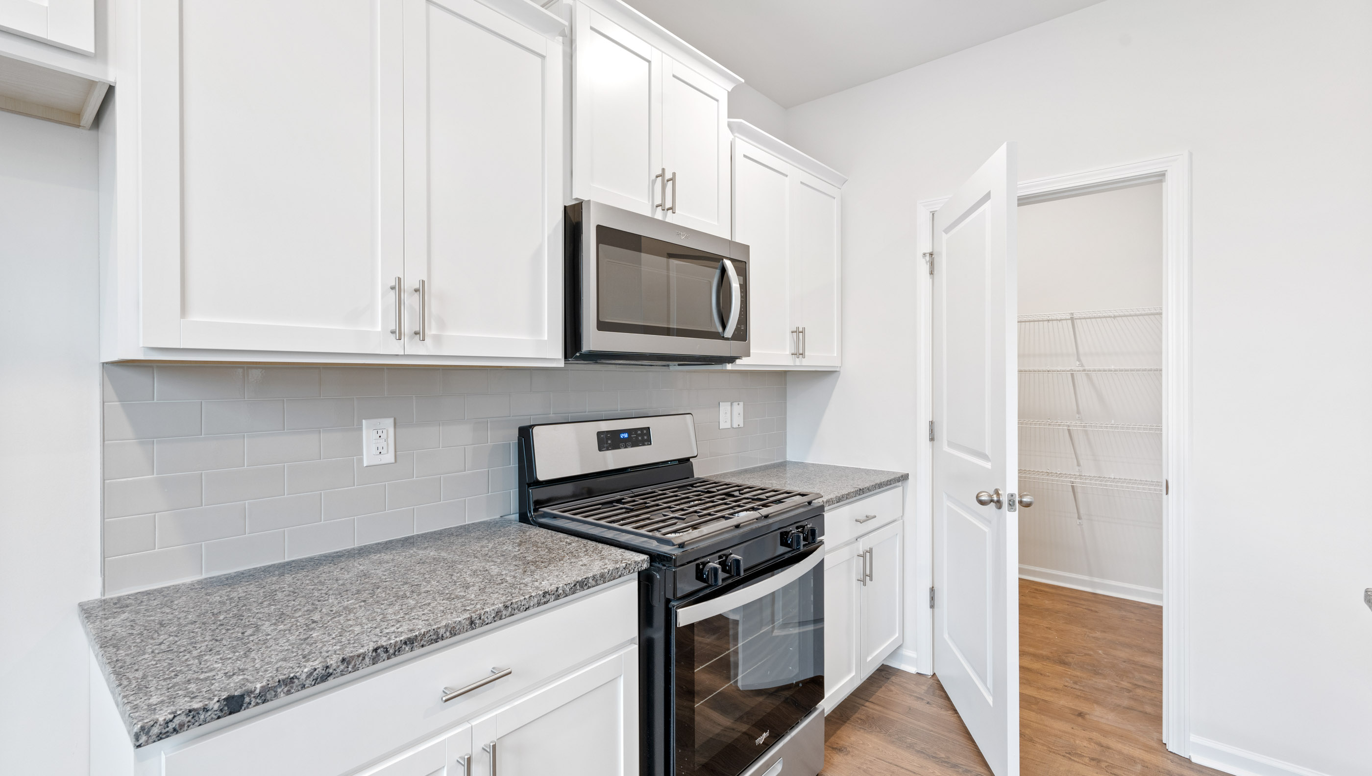 Kitchen with granite countertop and stainless steel appliances.