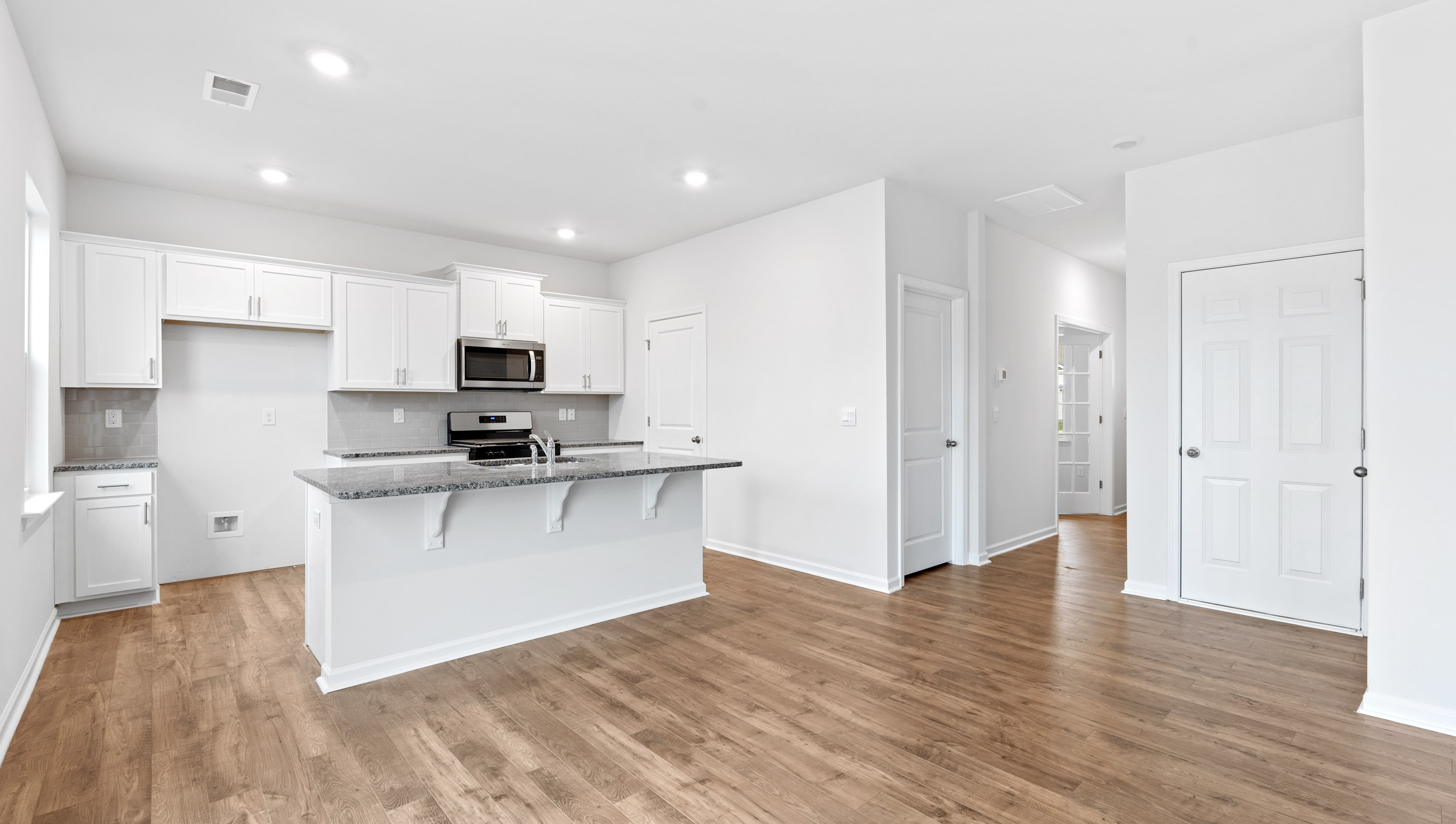 Kitchen and island with granite countertop.