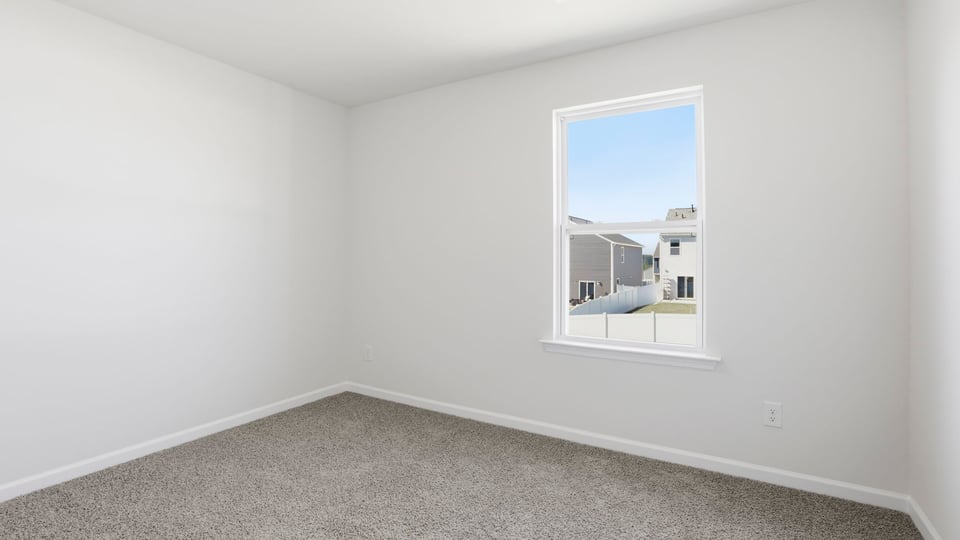 Bedroom with carpet and window.