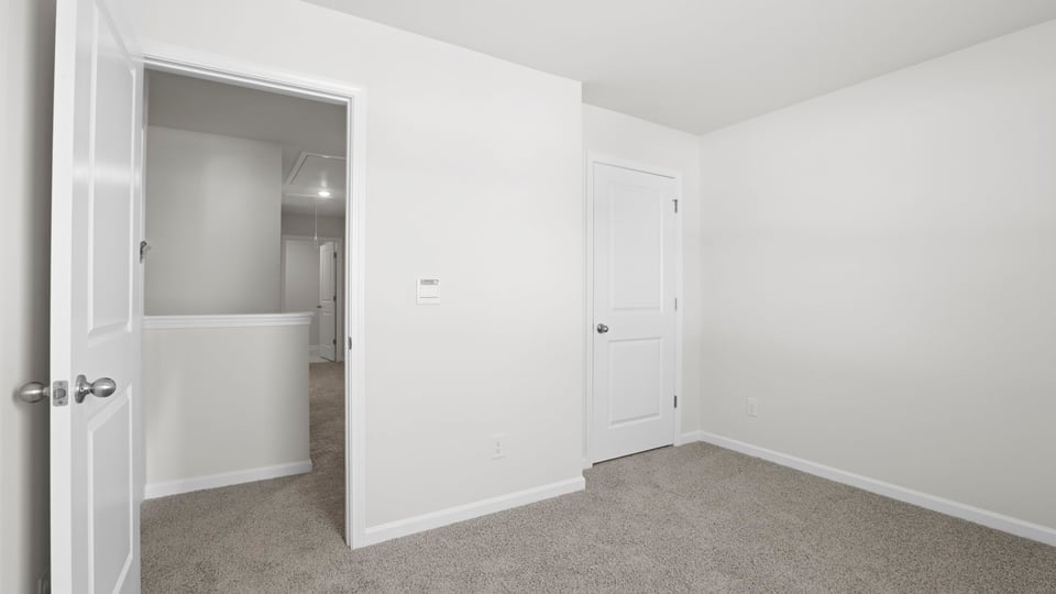 Bedroom with carpet and window.