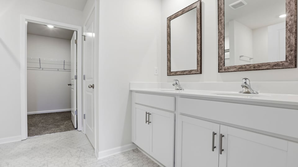 Bathroom with double vanity sink and clsoet.