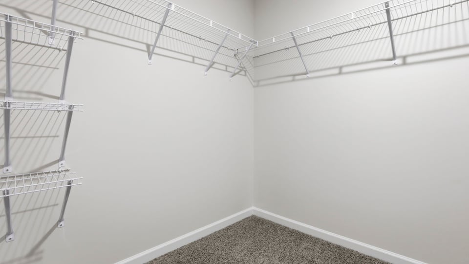 Closet with hanging storage racks.
