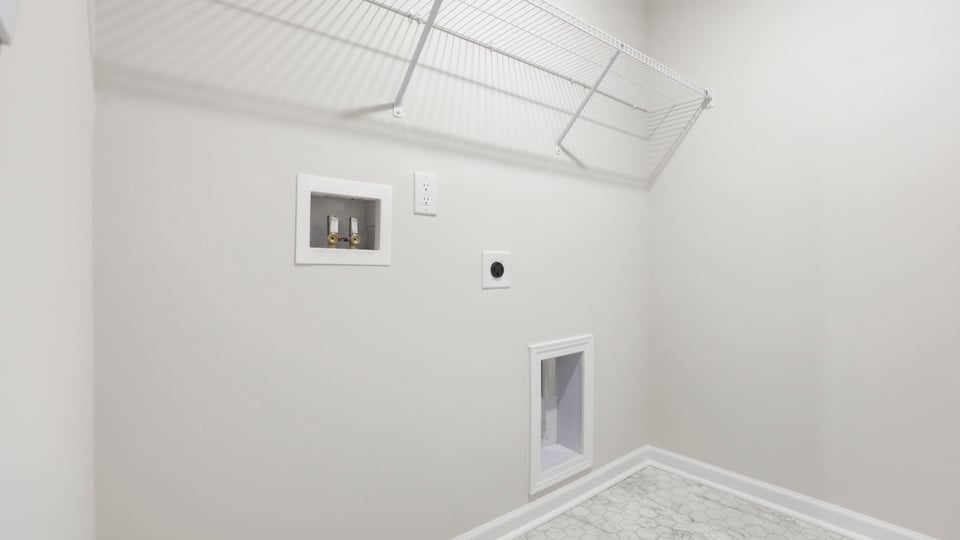 Laundry room with hanging storage racks.