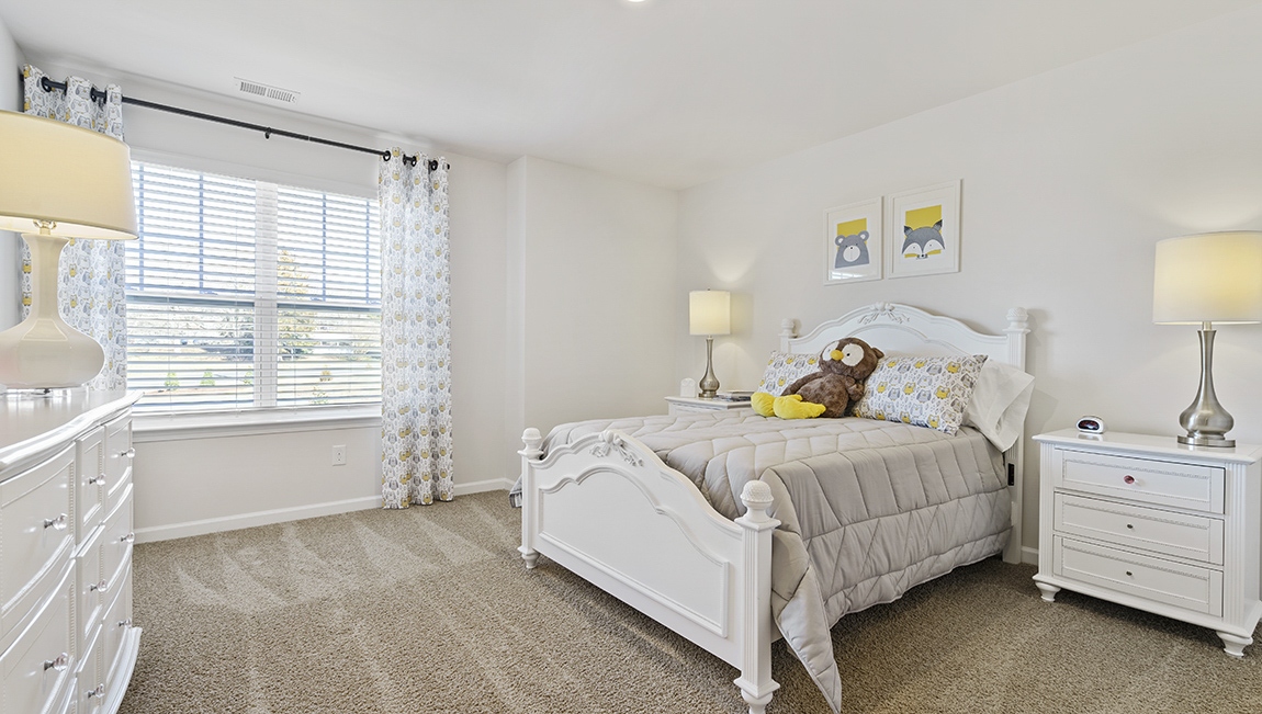 Bedroom with carpet and window.