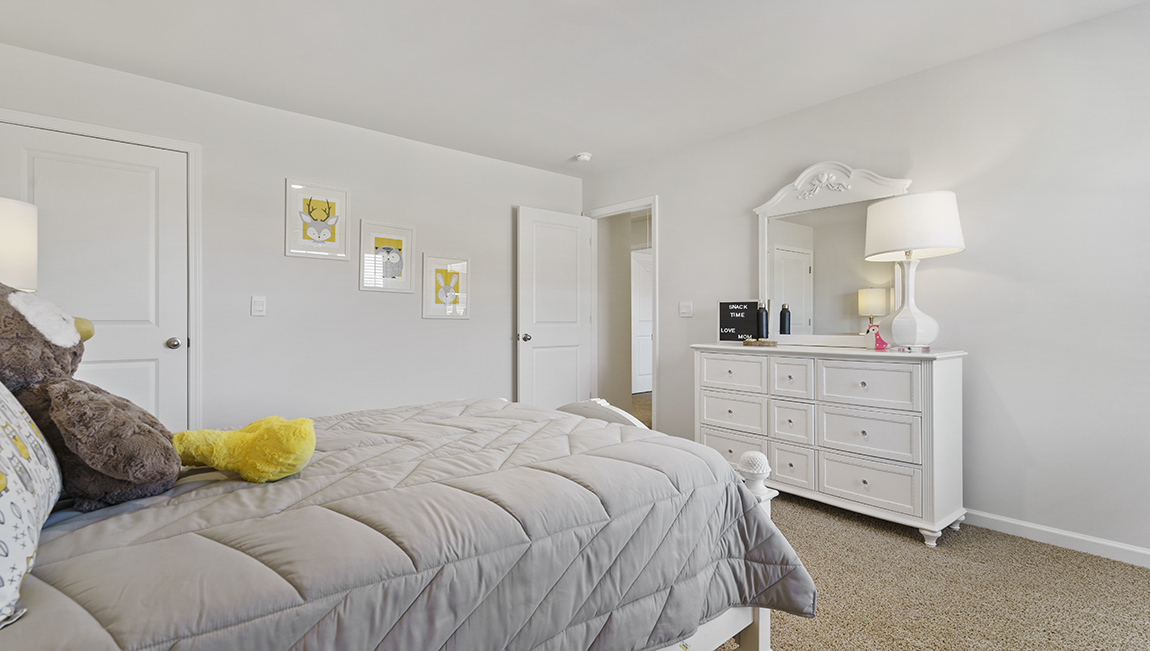 Bedroom with carpet and window.