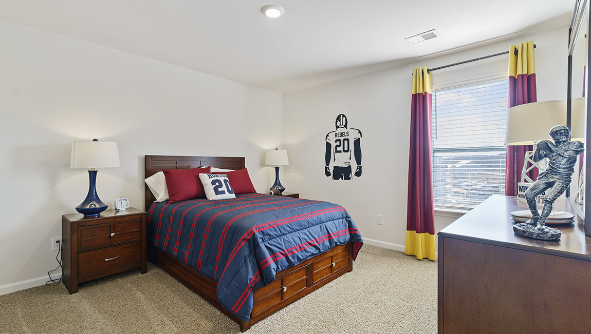 Bedroom with carpet and window.